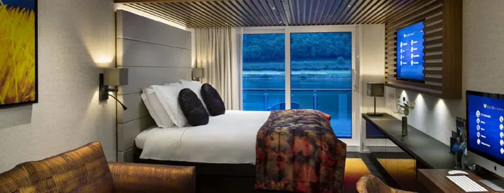 View of a standard stateroom with a balcony and Apple computer on the AmaMagna.