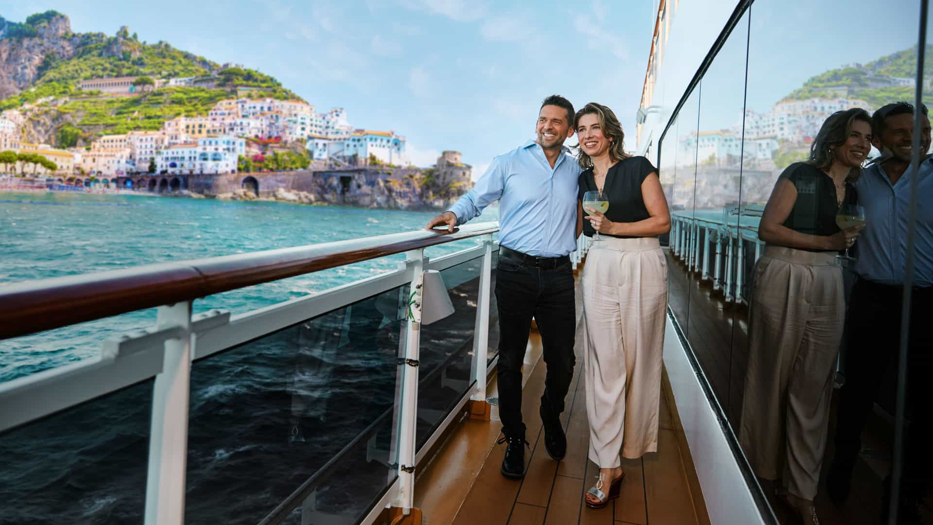 Romantic deck stroll at sea—guests aboard Holland America transatlantic cruise enjoying serene morning views.