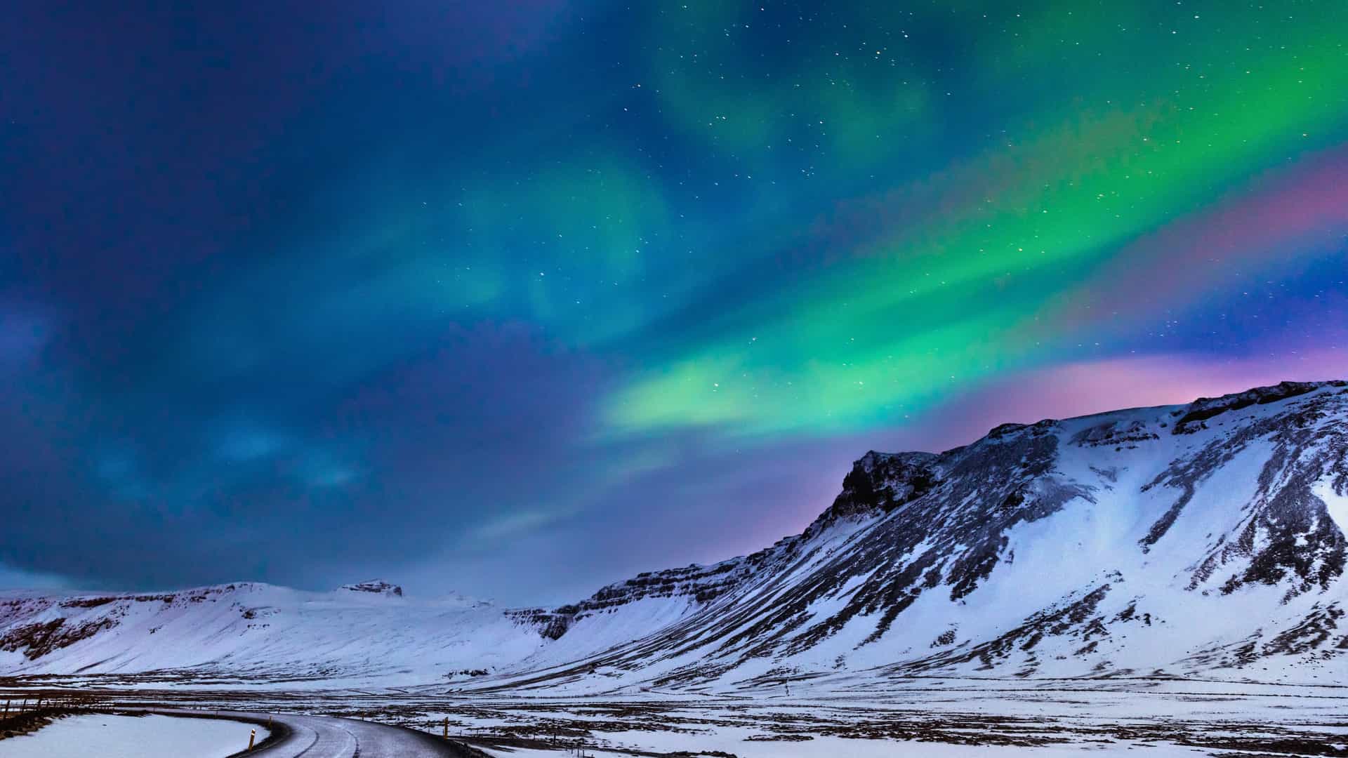 Witness the breathtaking Northern Lights dancing across the sky in a winter landscape near the Arctic Circle, an awe-inspiring experience on a Royal Caribbean cruise.