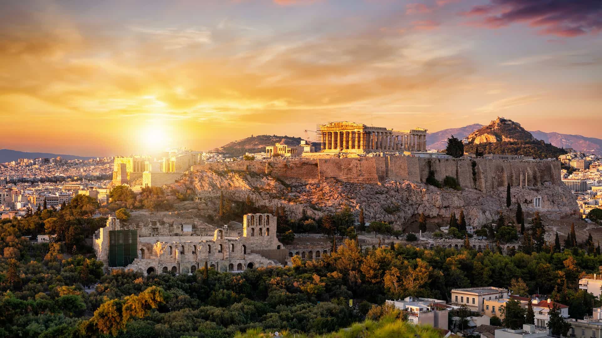 The ancient Acropolis and Parthenon of Athens, Greece, glow during sunset, a magnificent landmark to visit on a Royal Caribbean European cruise.