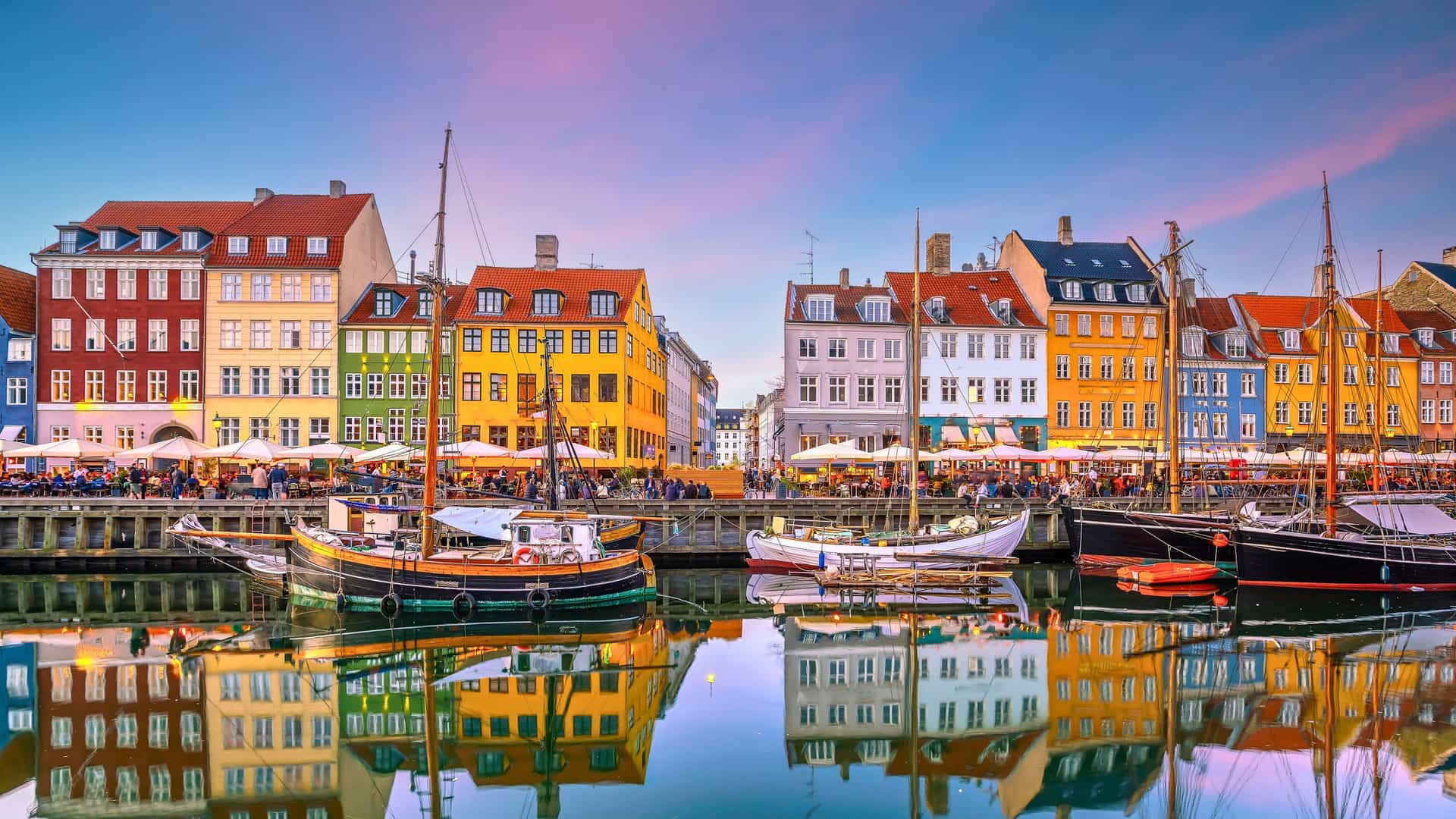 The vibrant Nyhavn harbor in Copenhagen, Denmark, with its colorful historic buildings and boats, a popular destination on a Royal Caribbean Northern Europe cruise.