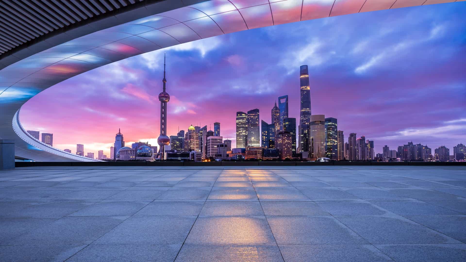 The futuristic Pudong skyline of Shanghai, China, glows at dusk, a magnificent view from a Royal Caribbean cruise sailing in Asia.