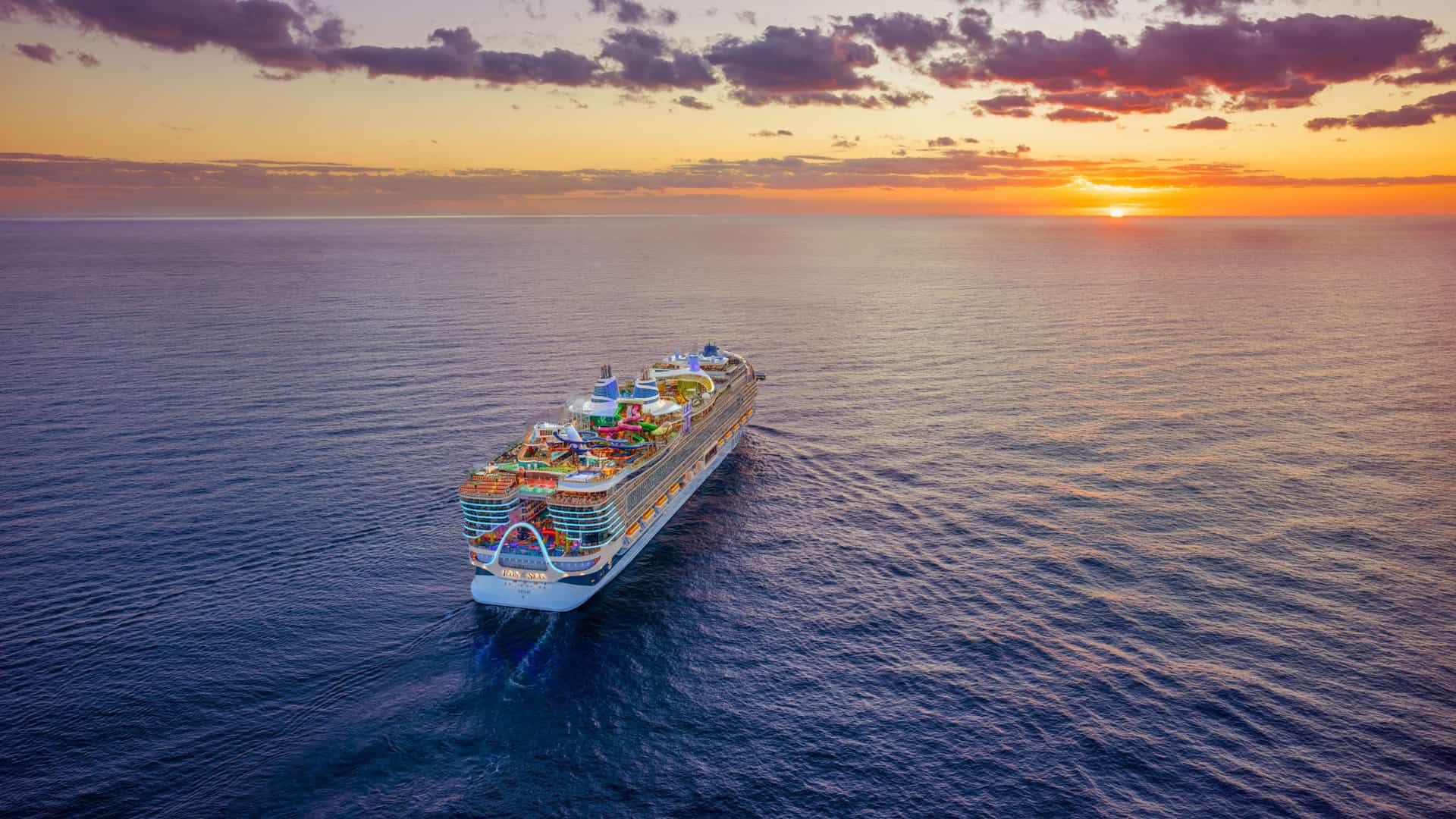 A Royal Caribbean cruise ship sailing in the Atlantic Ocean during a sunset on a Trans-Atlantic voyage.