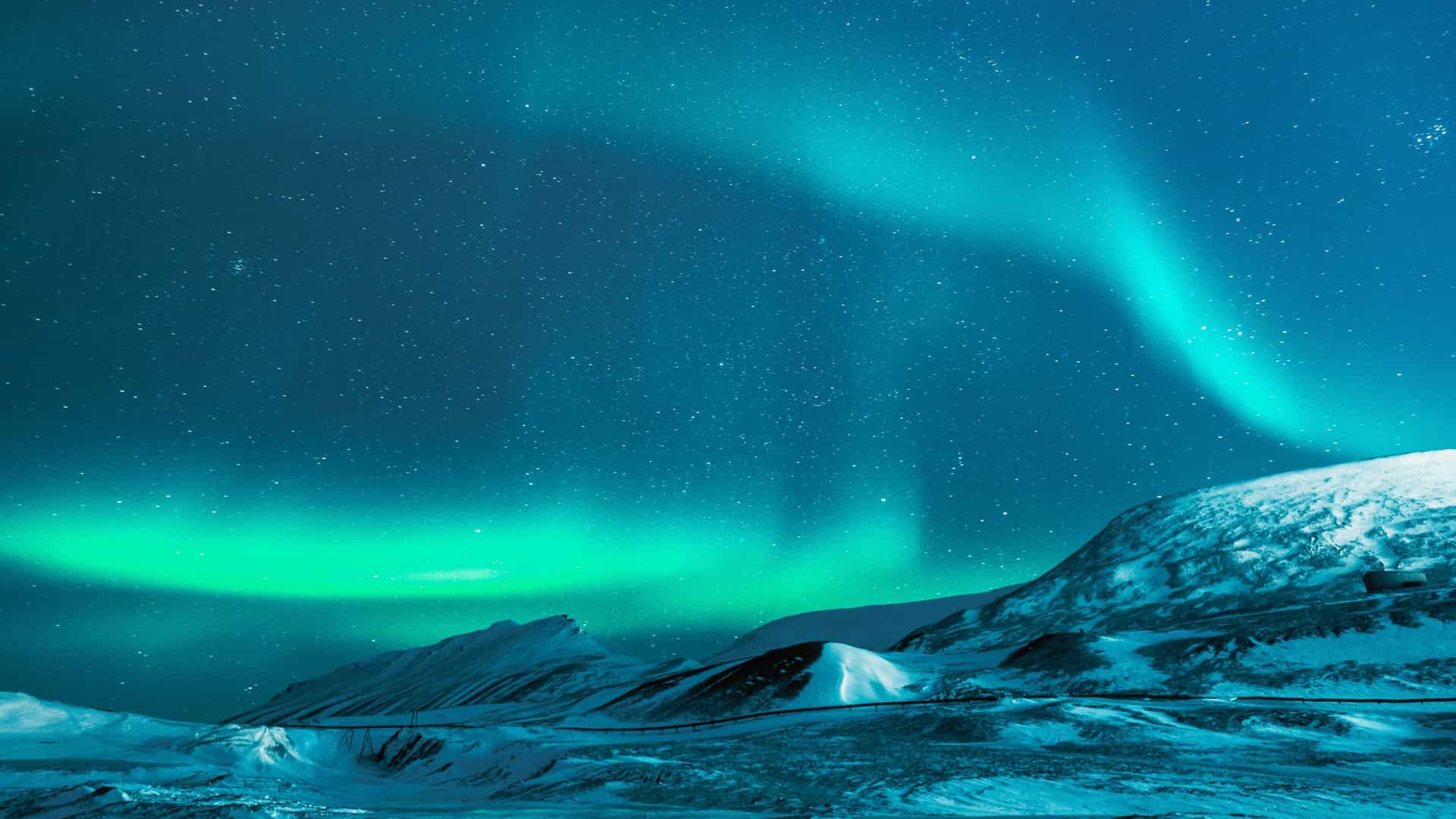 The spectacular Aurora Borealis, or Northern Lights, dancing across the Arctic sky, an unforgettable experience on a Seabourn cruise within the Arctic Circle.