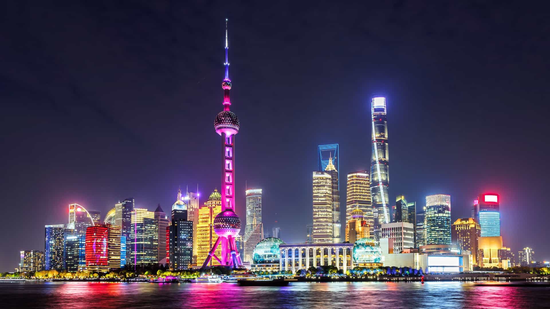 The vibrant, illuminated Pudong skyline of Shanghai, China at night, a spectacular port of call on a luxury Seabourn cruise in Asia.