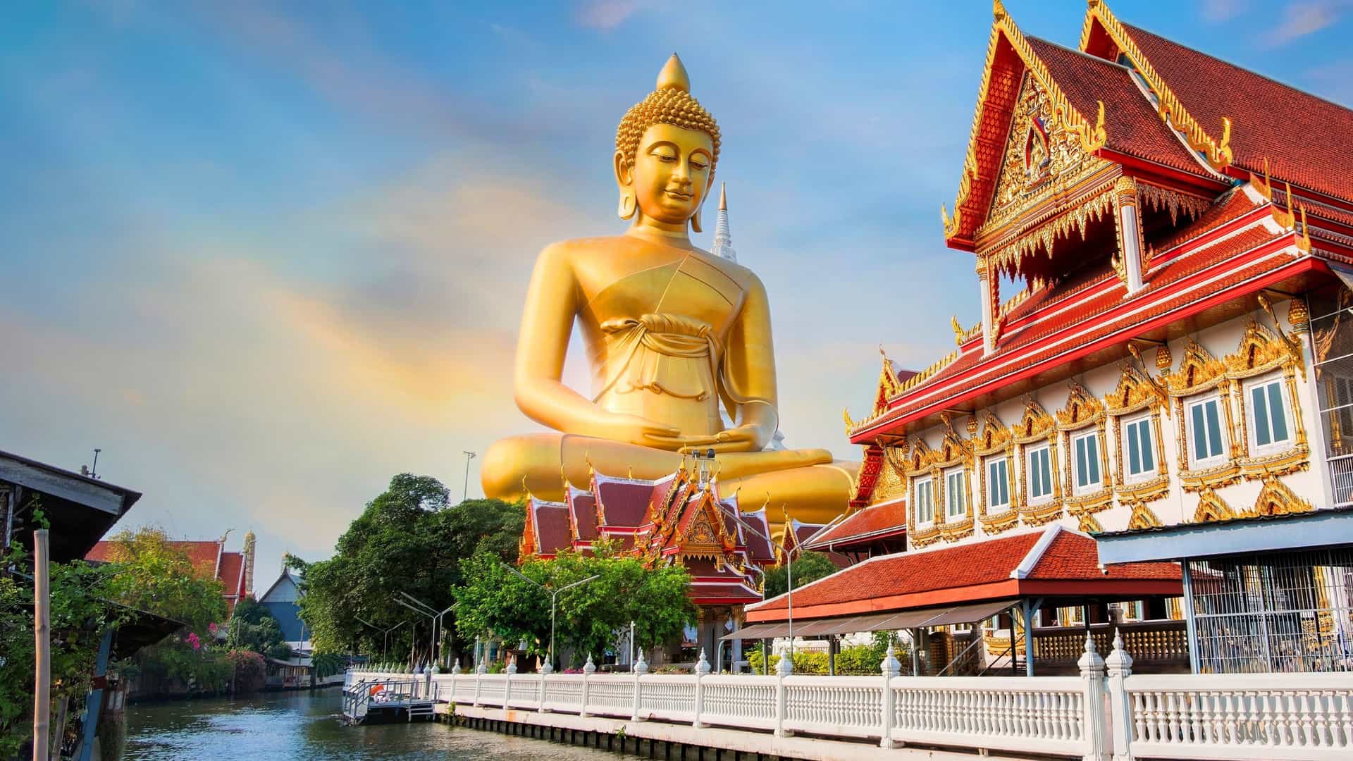 A magnificent golden Buddha statue at Wat Paknam Phasi Charoen in Bangkok, Thailand, a cultural highlight of a Seabourn cruise in Southeast Asia.