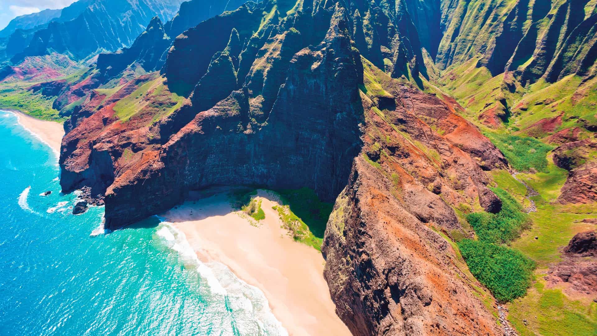 An aerial view of the majestic Na Pali Coast cliffs of Kauai, Hawaii, a stunning highlight of a Seabourn expedition cruise.
