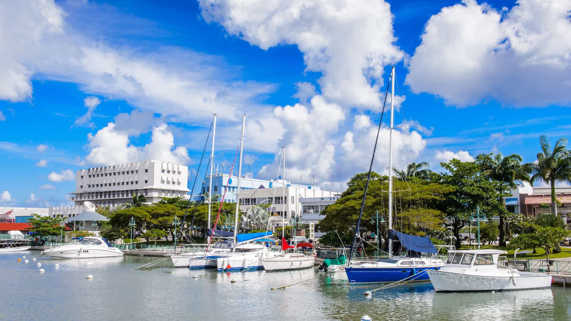 The scenic port of Bridgetown in the Caribbean island of Barbados, with moored yachts and a modern waterfront, a common stop for Silversea cruises.
