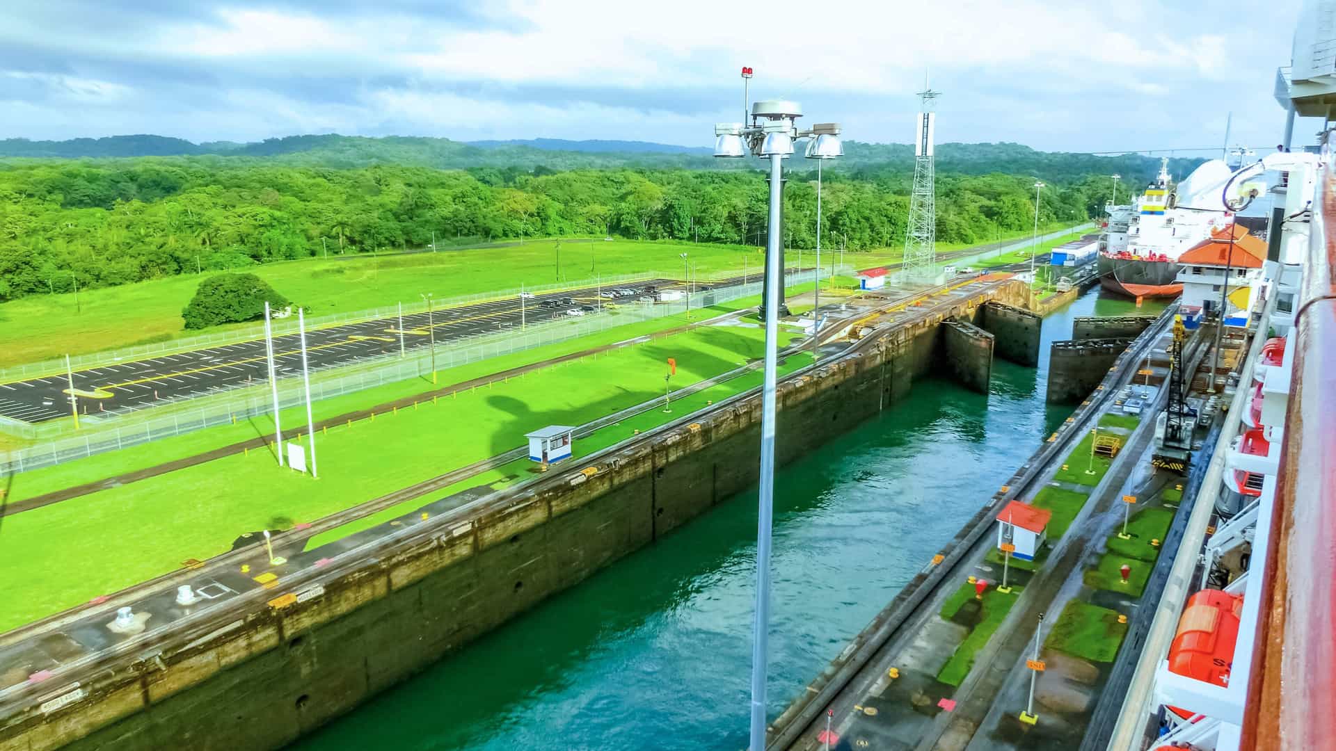 Ship passing through the Panama Canal lock system, surrounded by lush greenery—an iconic transit experience on Viking Expedition Cruises.