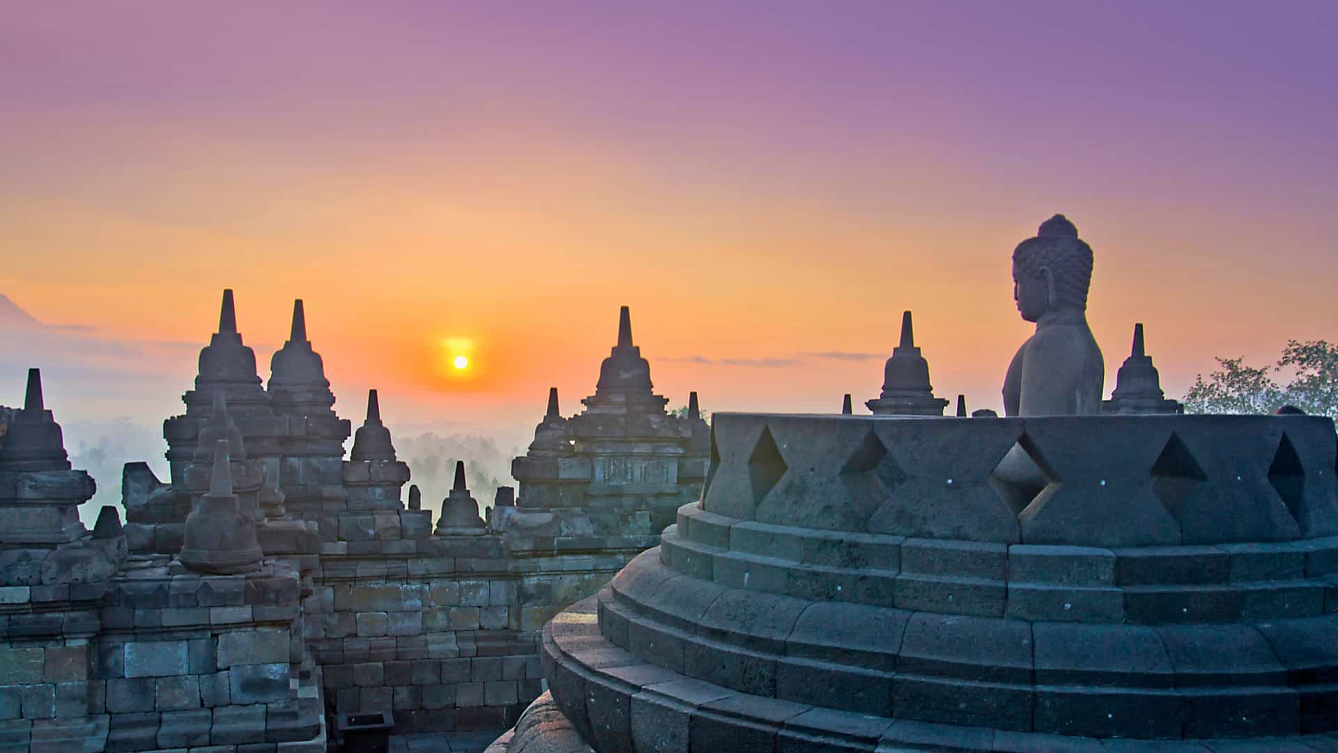 Sunrise over the ancient Borobudur Temple in Java, Indonesia, a stunning cultural and historical landmark on Viking Ocean cruise itineraries in Asia.