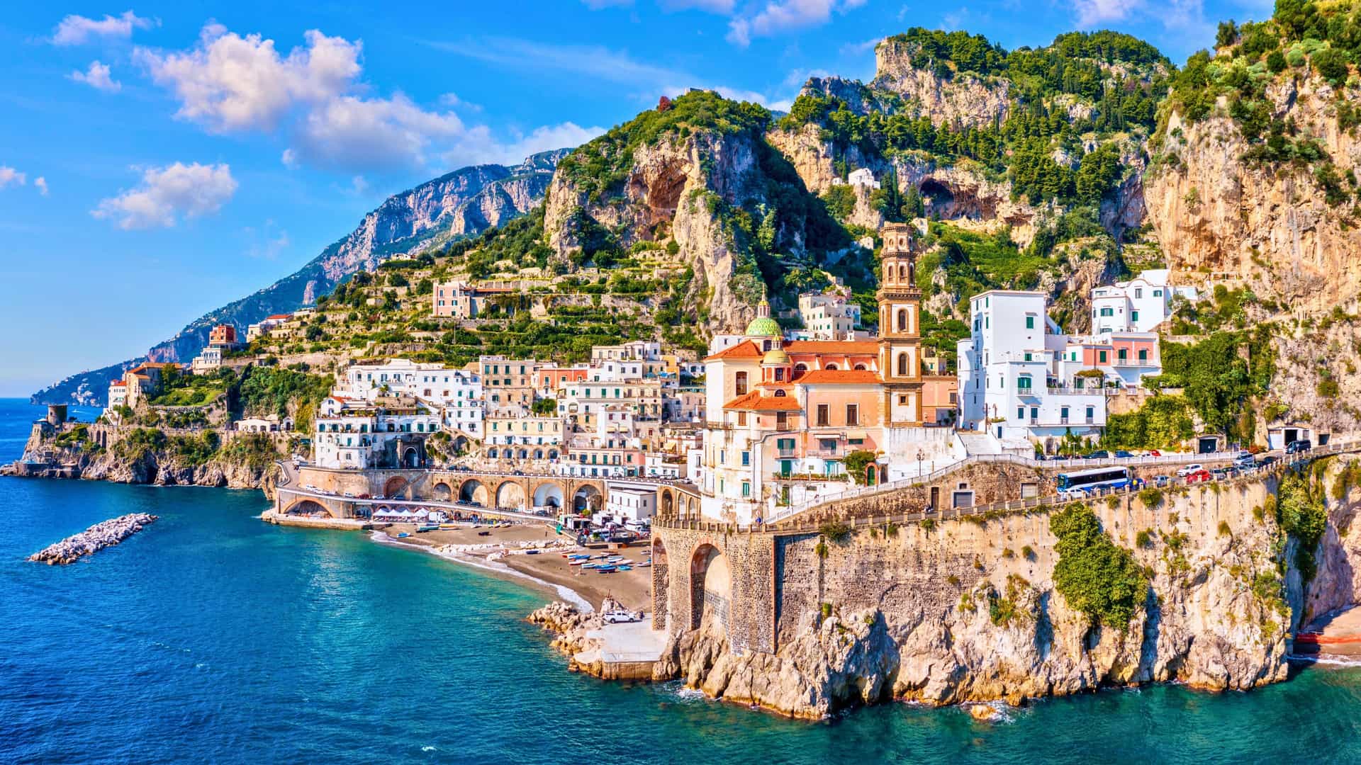 Scenic view of the Amalfi Coast in Italy, with colorful houses built into cliffs overlooking the Mediterranean Sea, a Windstar cruise destination.