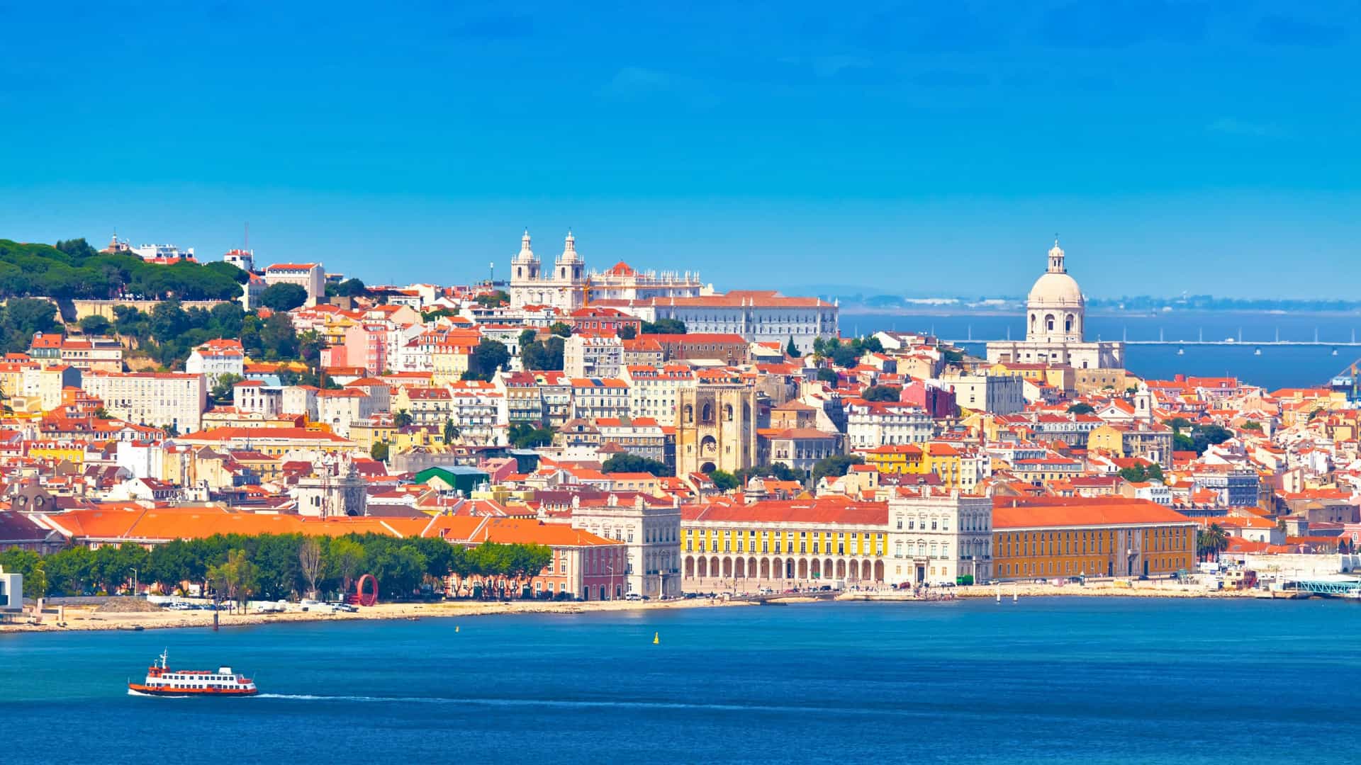 Panoramic view of the colorful Lisbon, Portugal skyline along the Tagus River, a European port of call for a Windstar cruise.