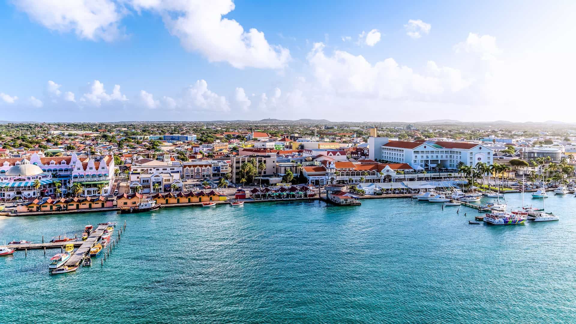 Colorful buildings along the waterfront of Oranjestad, Aruba, a vibrant port of call for a Windstar cruise in the Southern Caribbean.