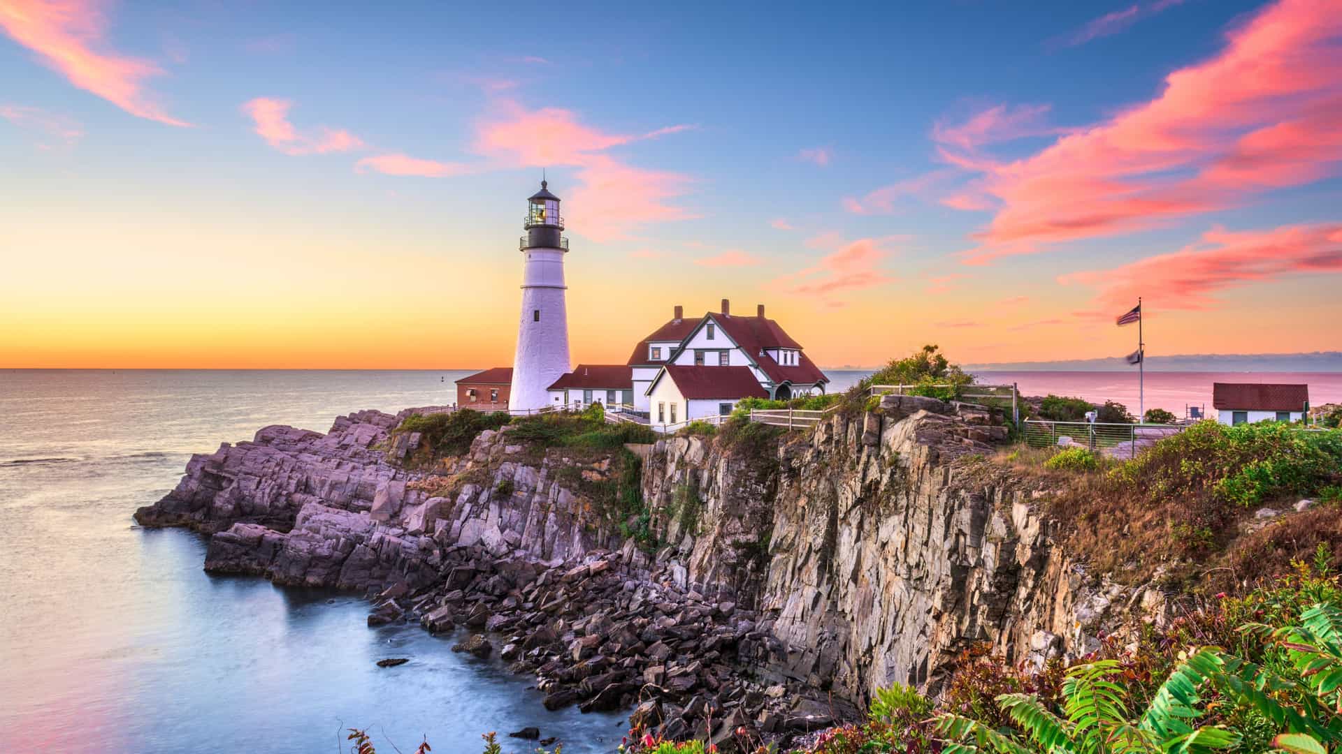 A scenic view of Portland Head Lighthouse at sunrise in Maine, a highlight of a Windstar cruise in New England and Canada.