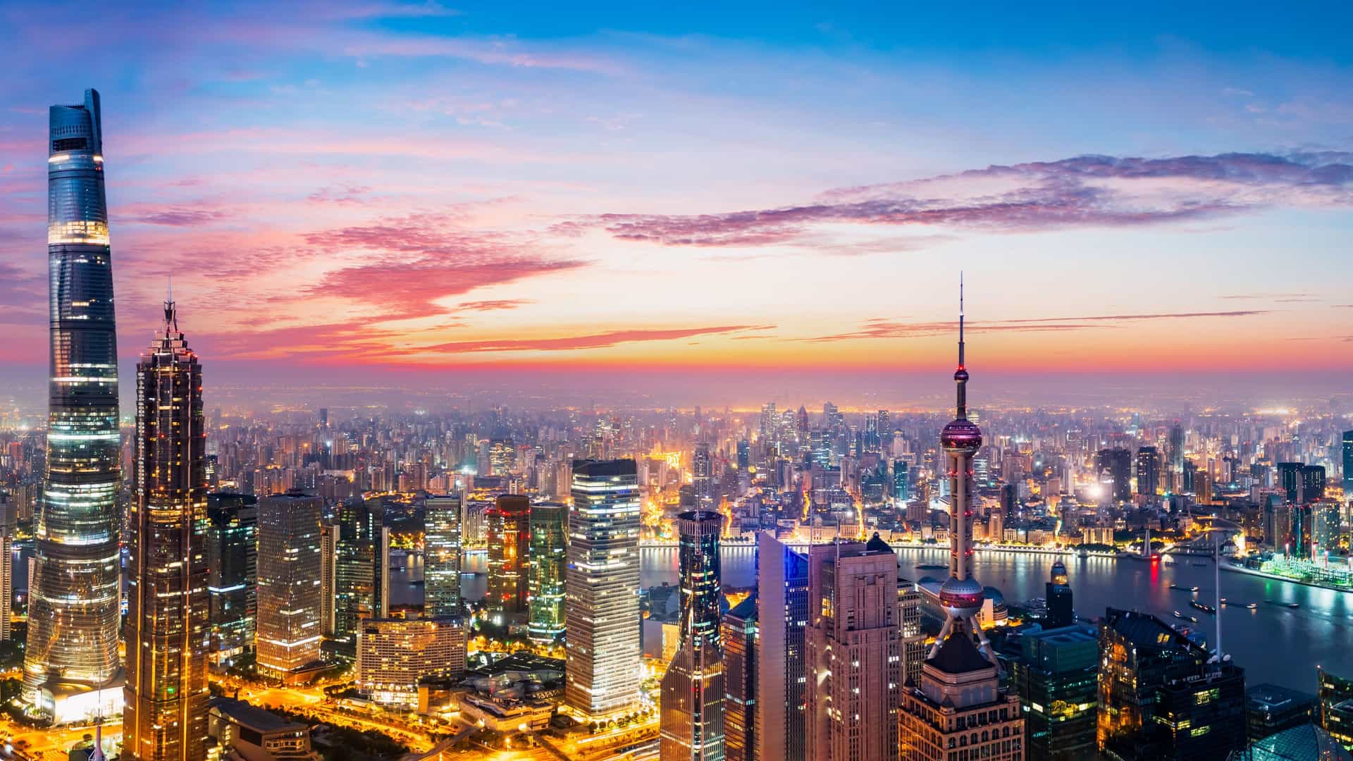 Panoramic view of the illuminated Shanghai skyline at dusk in China, a destination for a Windstar cruise.