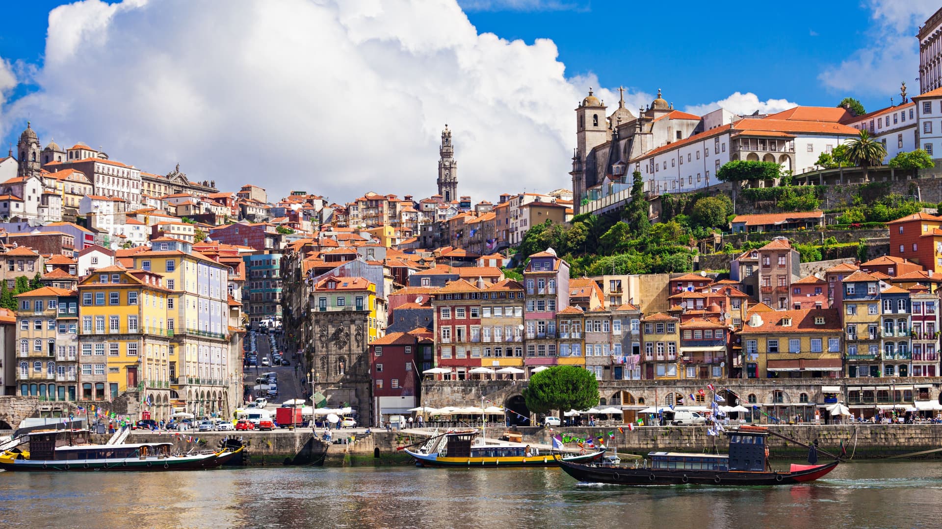 Small river ferry boats sailing the Douro River in Porto, Portugal.