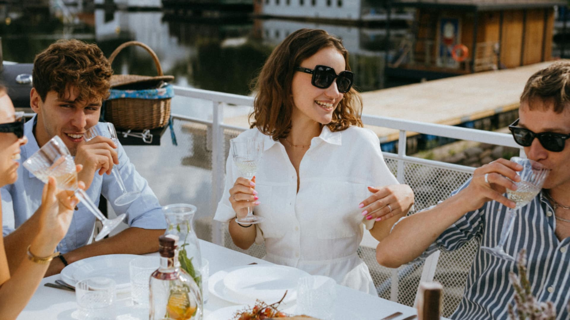 4 smiling people having lunch on a small cruise ship's deck.