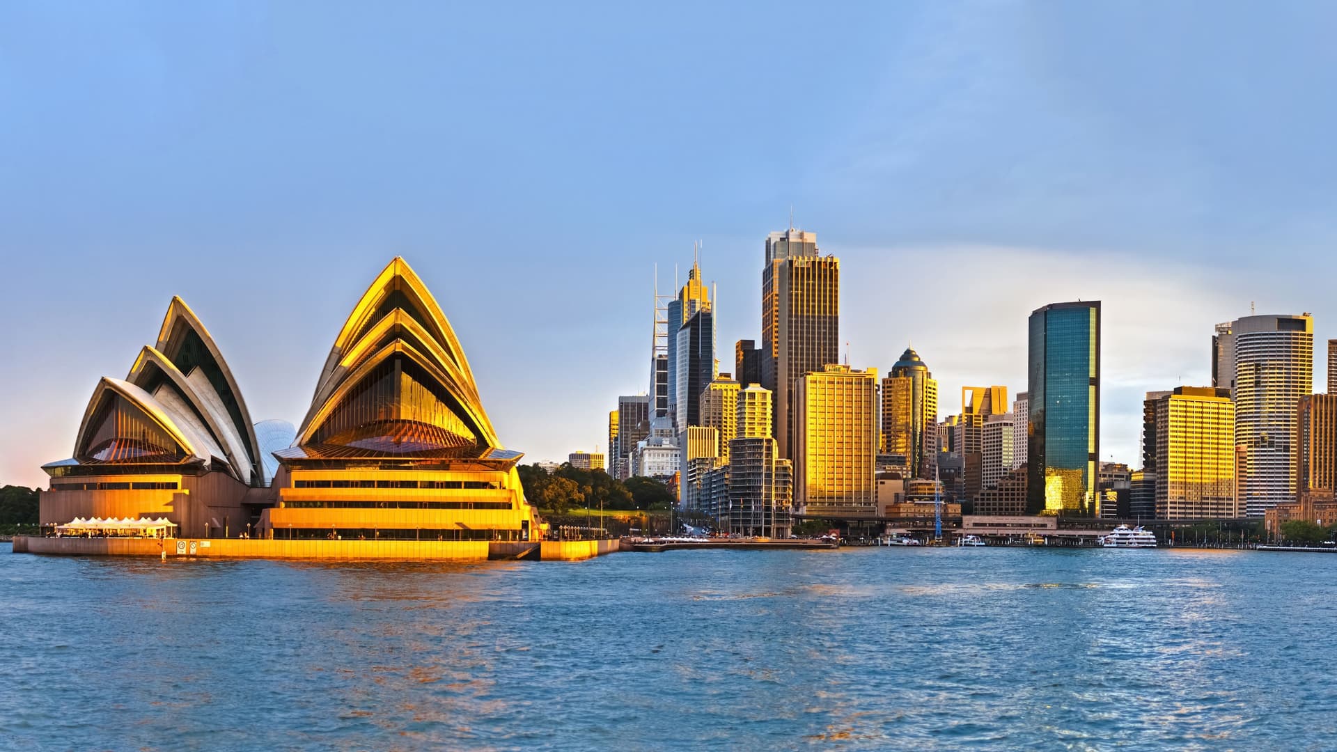 Sydney Opera House and city skyline at sunset.