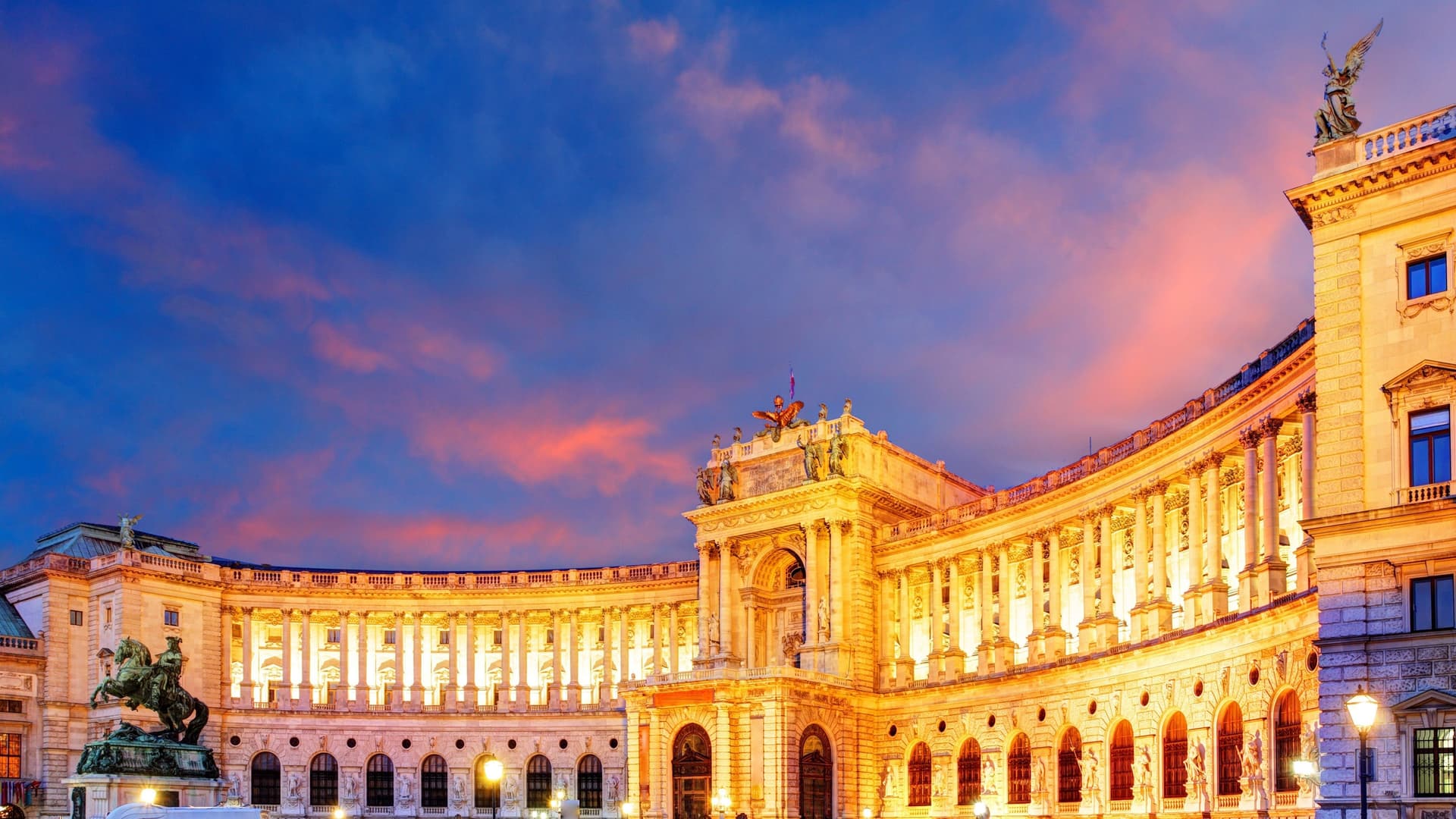Hofburg Palace illuminated at dusk in Vienna, Austria.