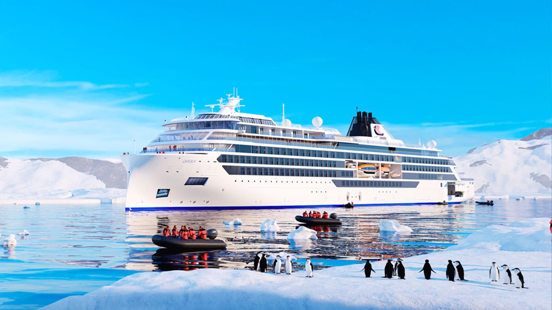 Viking Polaris sailing by penguins and guests in a Zodiac.