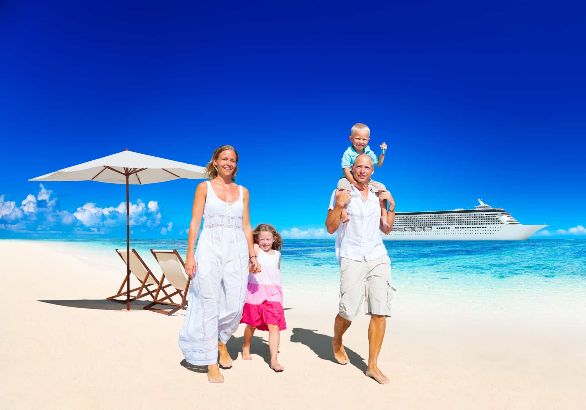 A family walking on the beach with a cruise ship in the background.
