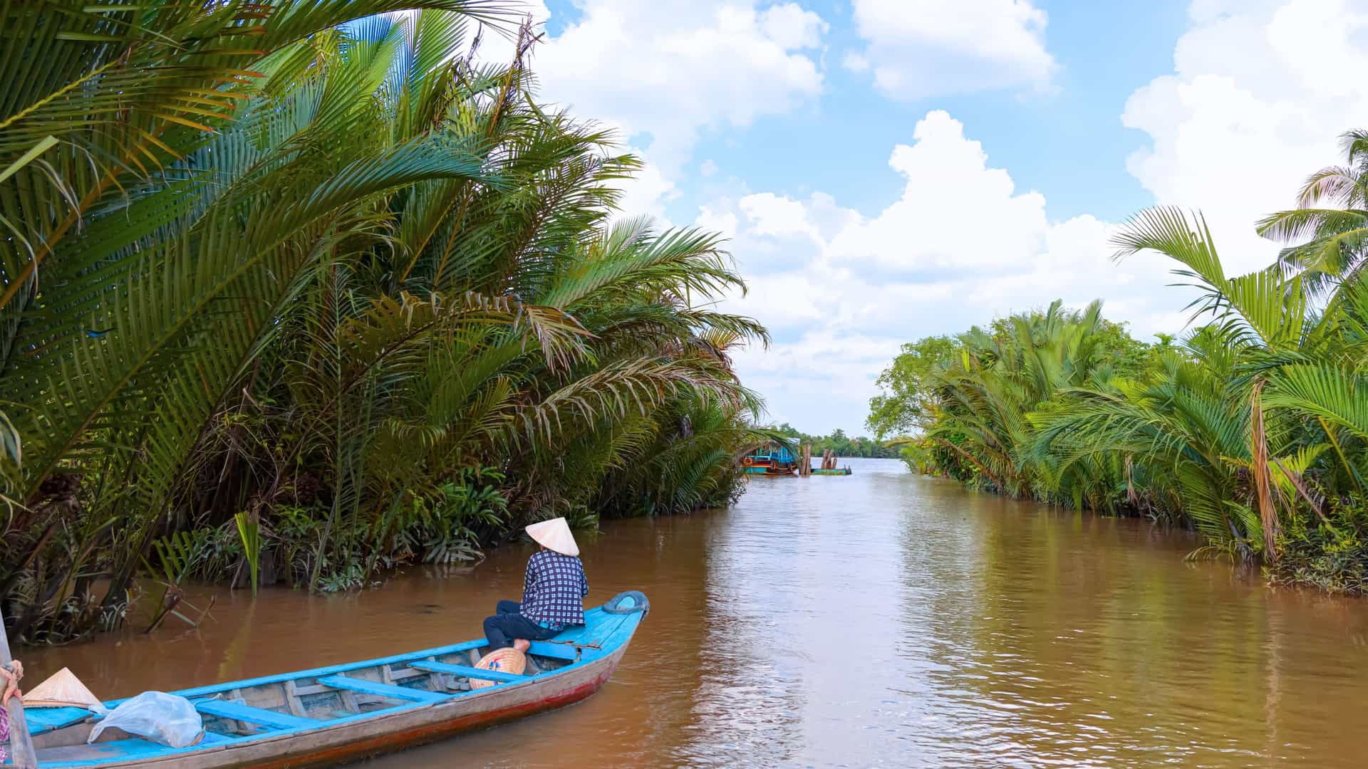 Traditional boat navigating a canal in Vietnam’s Mekong Delta, a highlight of AmaWaterways Mekong River cruises.