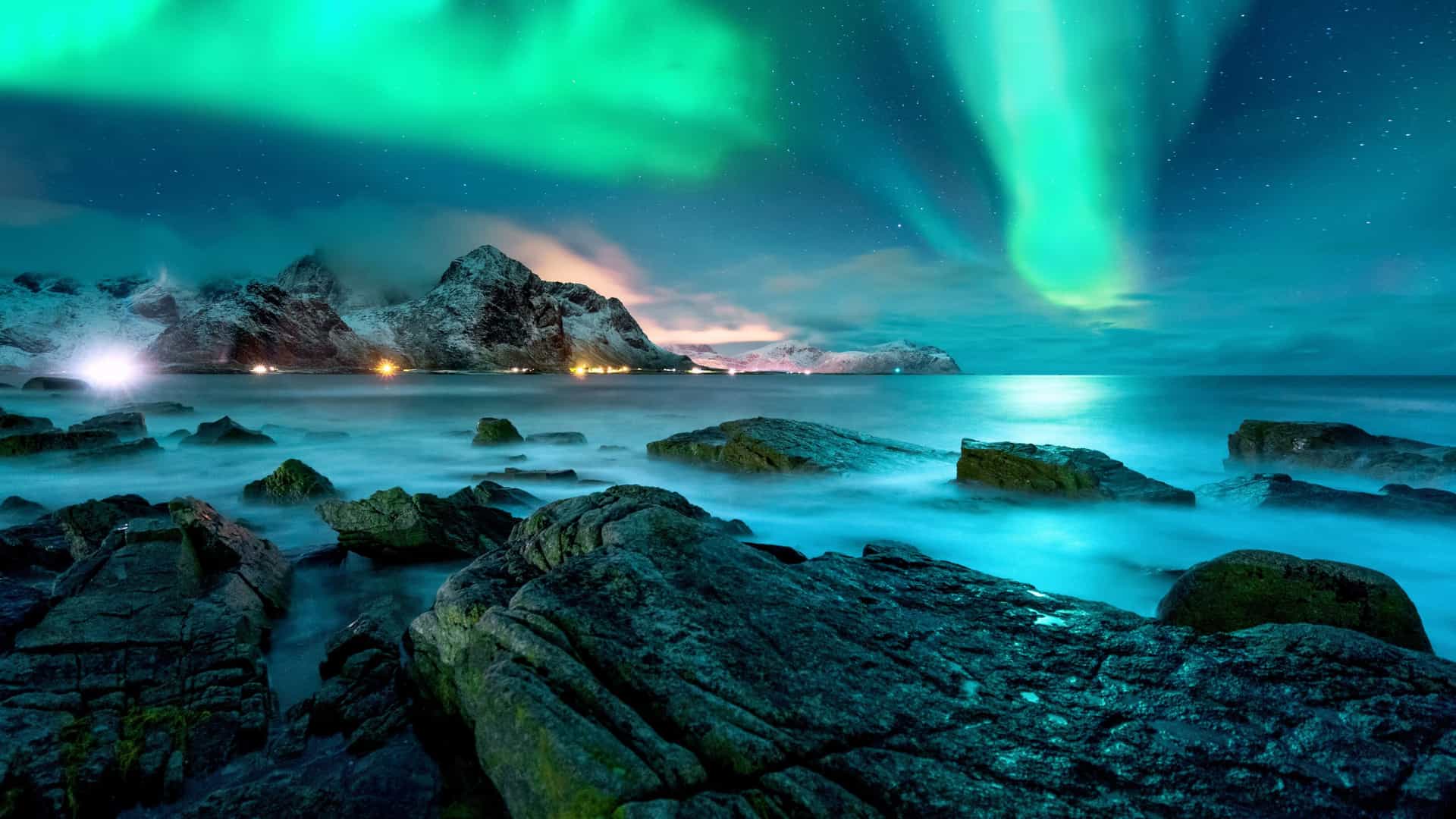 Azamara Cruises Arctic Circle voyage with vibrant Northern Lights over Norwegian mountains and coast.