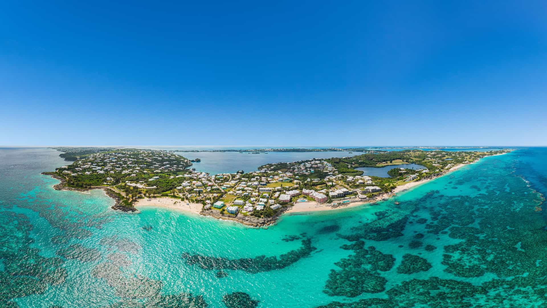 Aerial view of Bermuda's pink sand coastline with turquoise waters, a perfect Holland America Cruise destination.