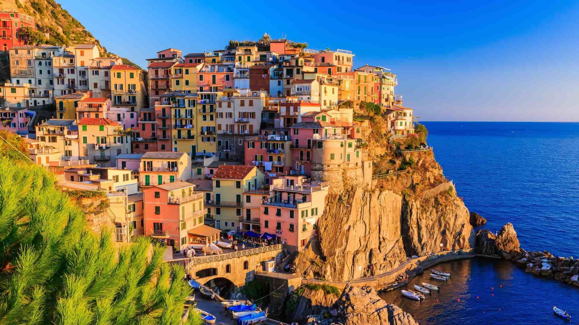 Brightly colored buildings of a cliffside village in Cinque Terre, Italy.
