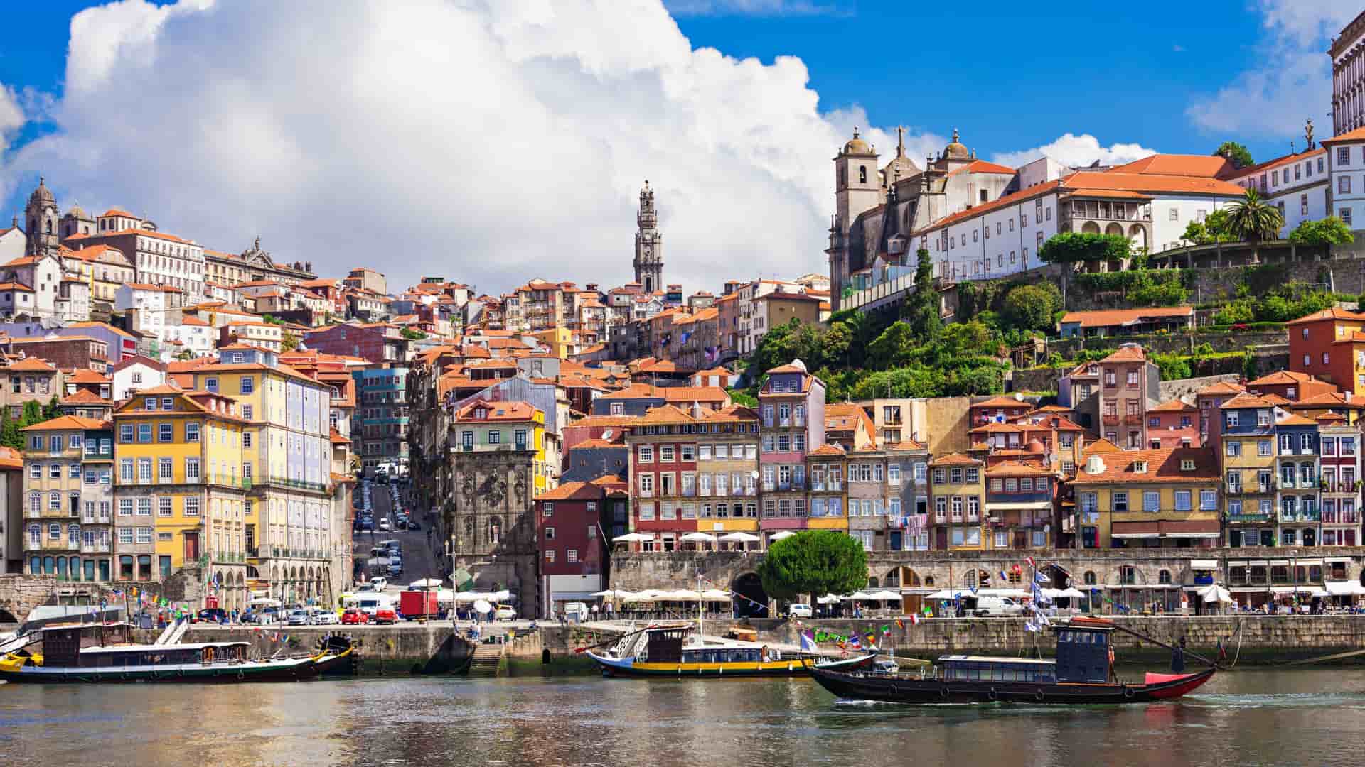 Small river ferry boats sailing the Douro River in Porto, Portugal.