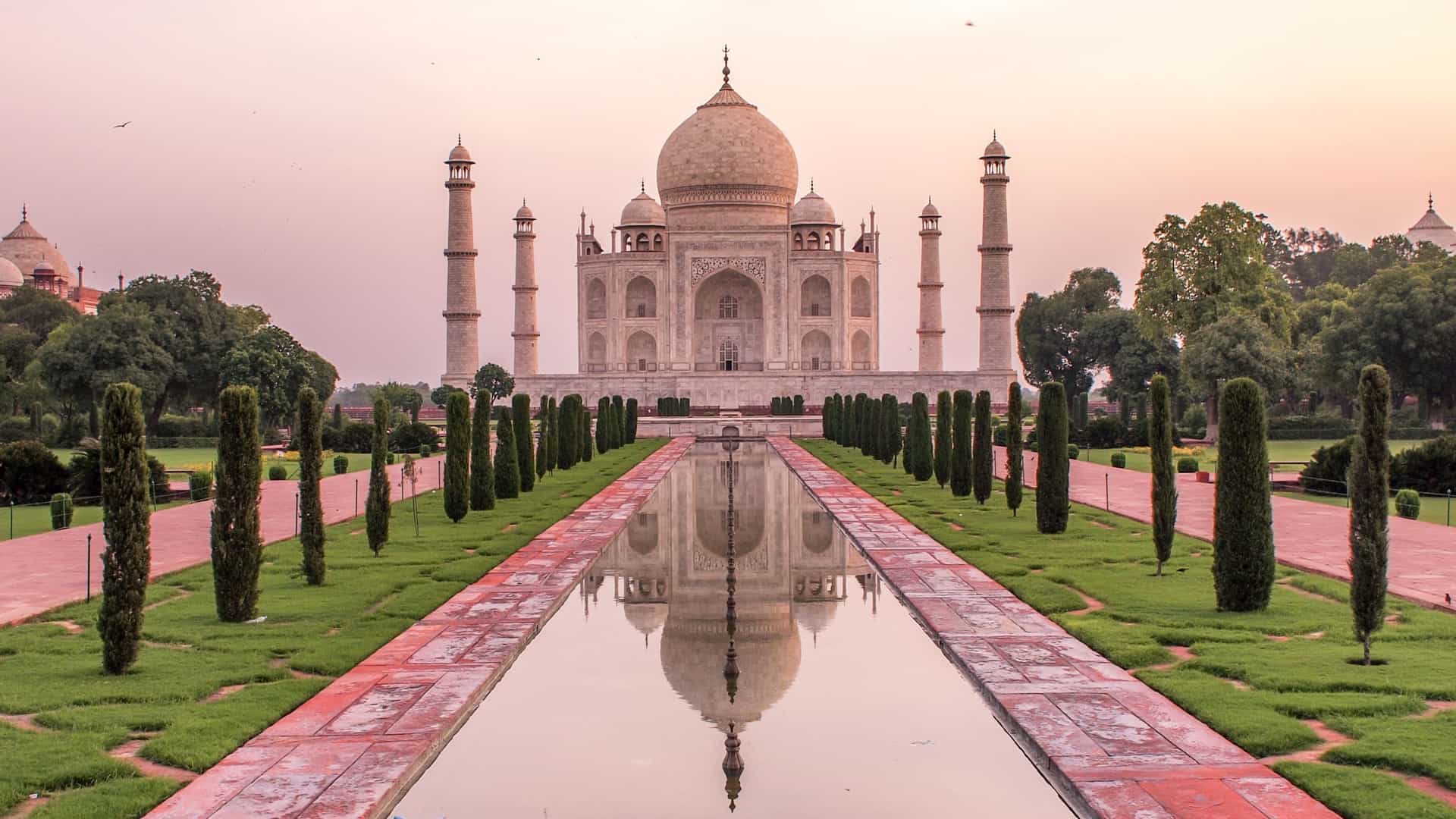 Taj Mahal in Agra, India, reflected in a pool at sunset on a Celebrity Cruises Asian itinerary.