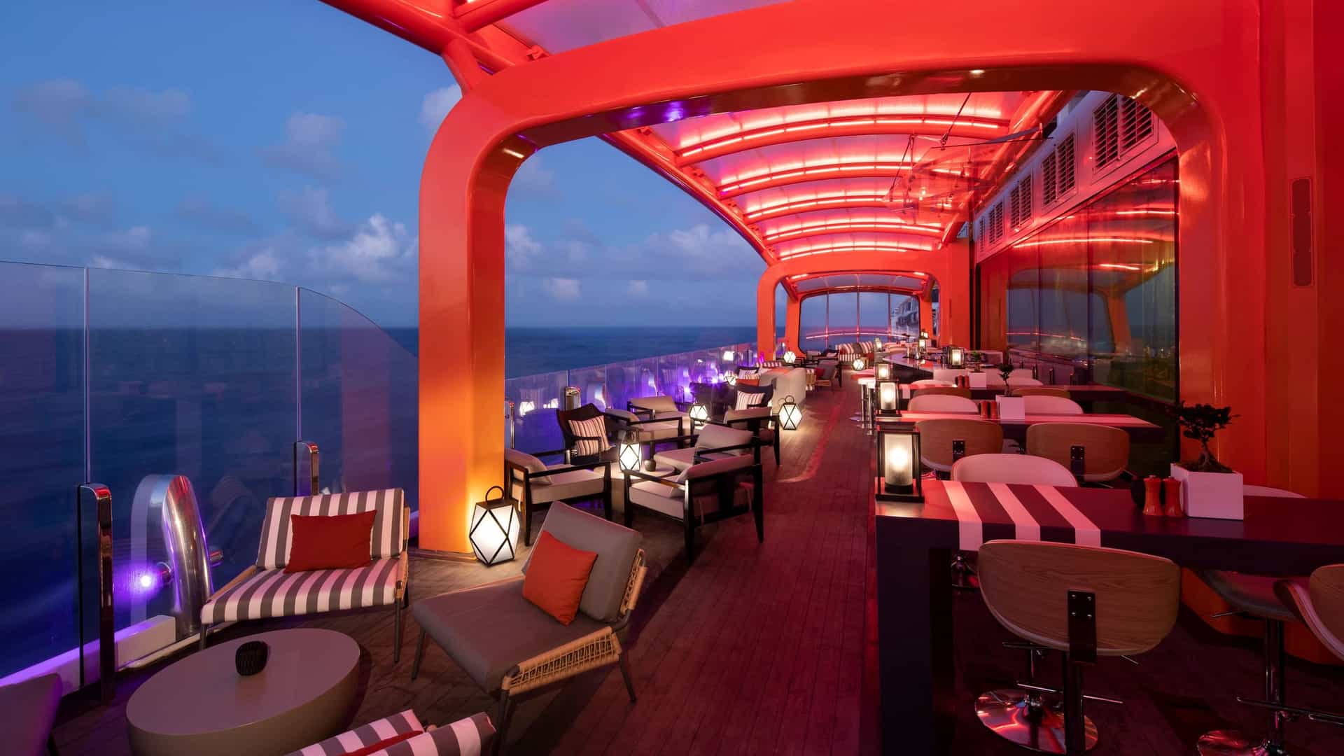 An image showing the depth, the orange painted arches, and the calm atmosphere of the famous Magic Carpet aboard Celebrity's Edge class ships.