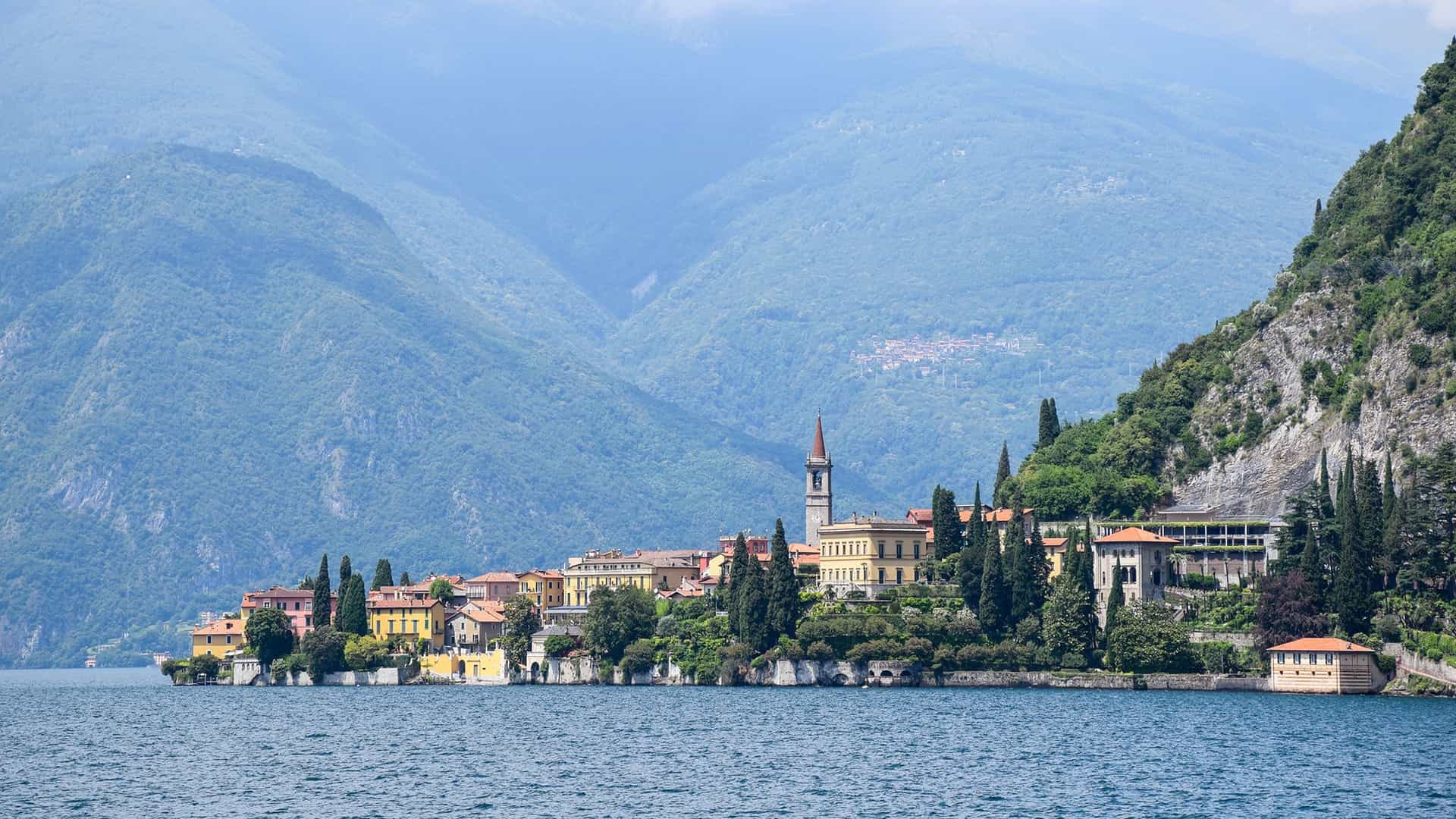 Village on Lake Como with mountains.