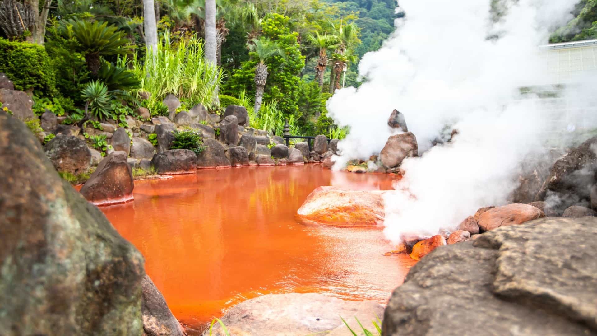 Close up photo of the Blood Pond hot springs in Beppu, Japan.