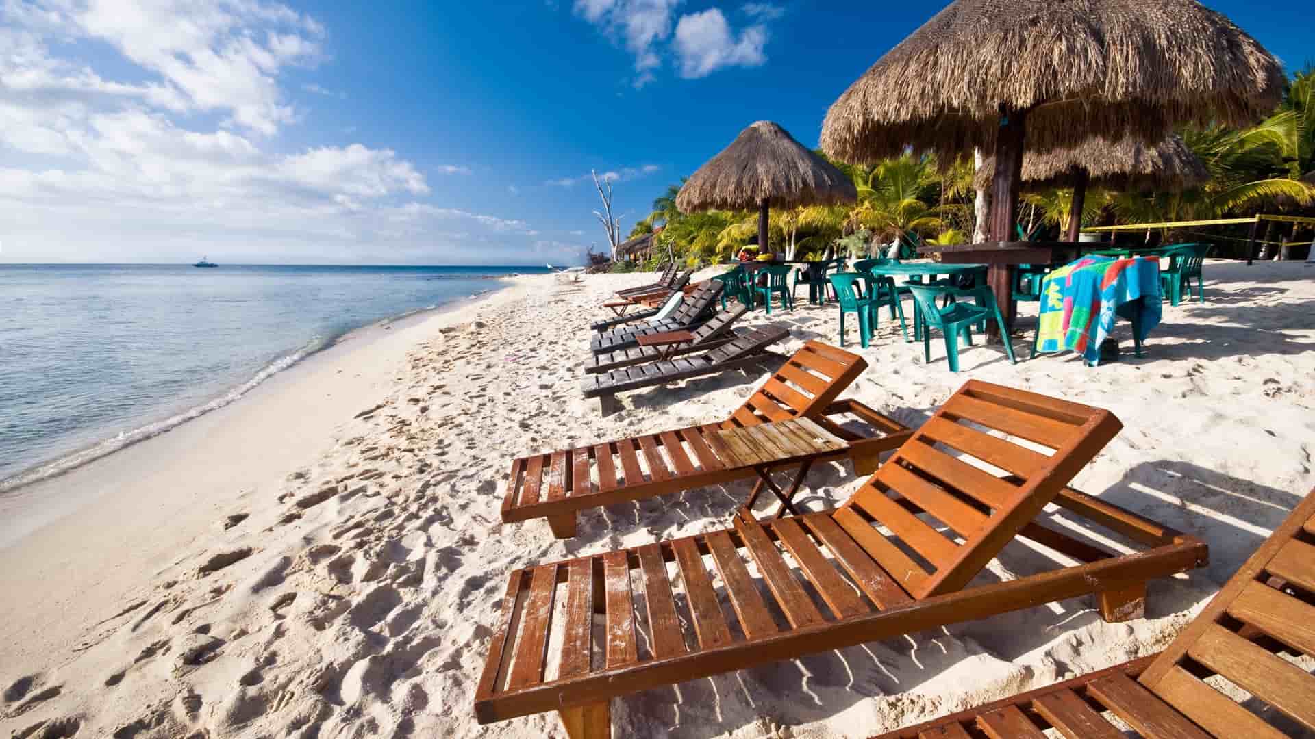 Tropical beach with lounge chairs in Cozumel.