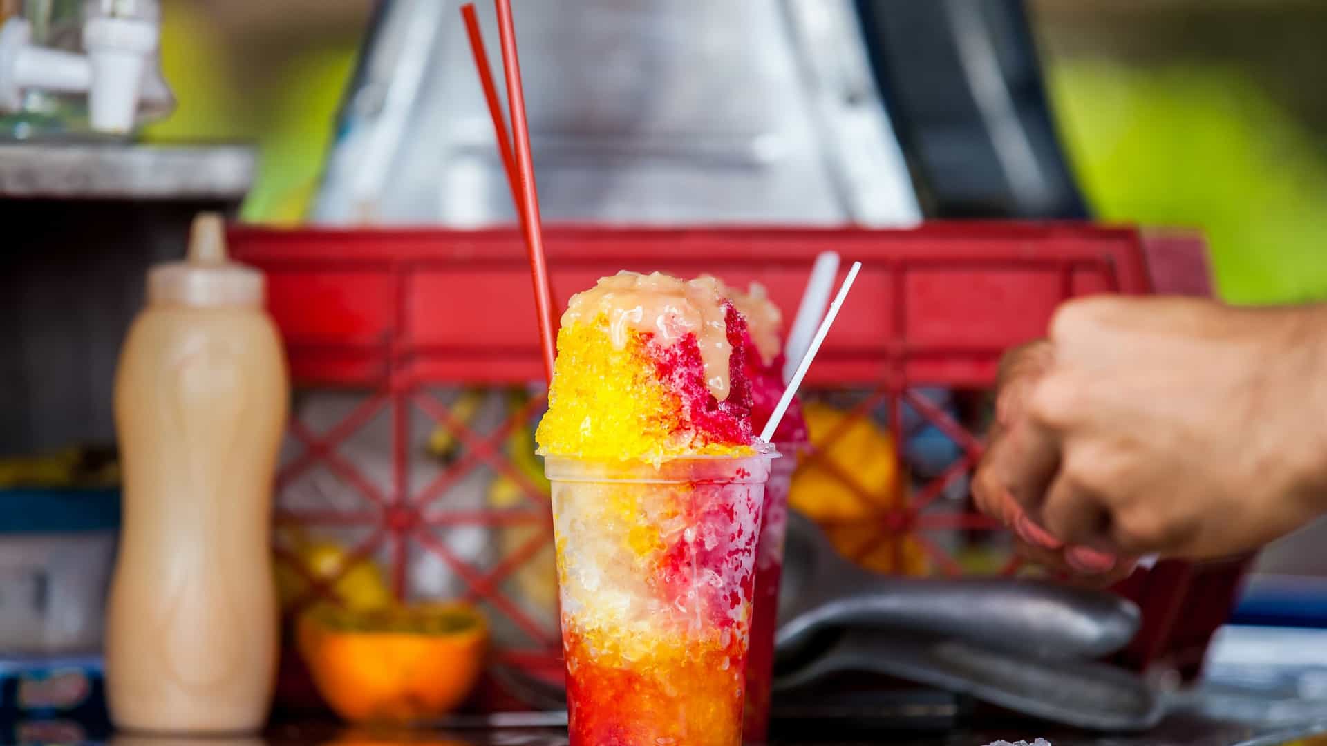 A street vendor in the city of Cali, Colombia, preparing and selling a traditional sweet water ice dessert known as "cholado."