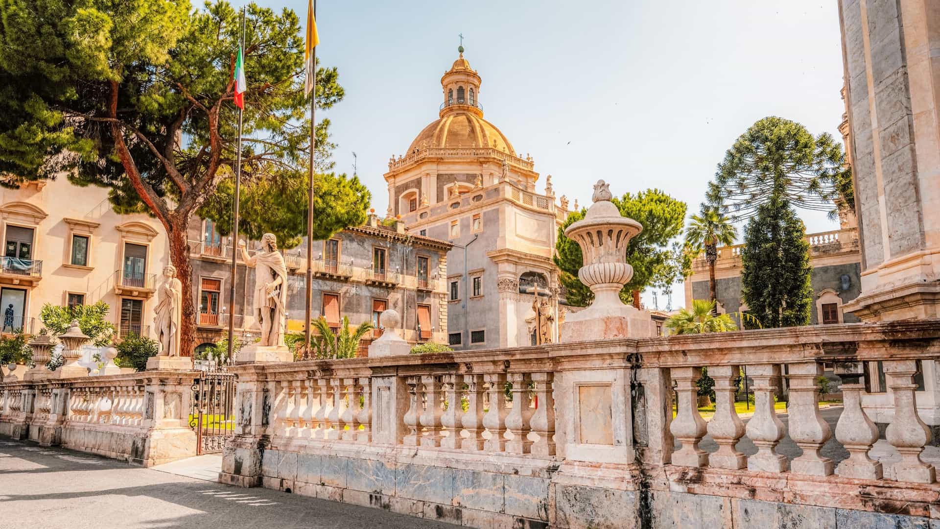 A view of the Cathedral of Sant'Agata (Duomo di Catania) on Piazza Duomo in Catania, Sicily, Italy, featuring the cathedral's Baroque facade and the Elephant Fountain (Fontana dell'Elefante).