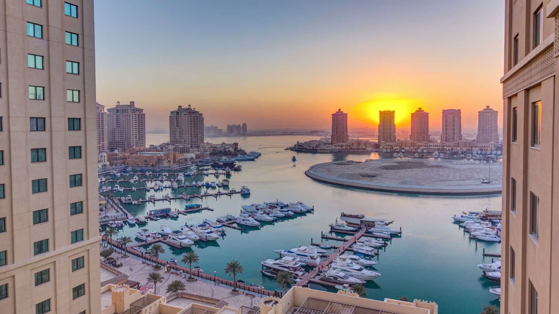 A top view timelapse of The Pearl-Qatar, an artificial island near Doha, showcasing the development and sunset over the marina.
