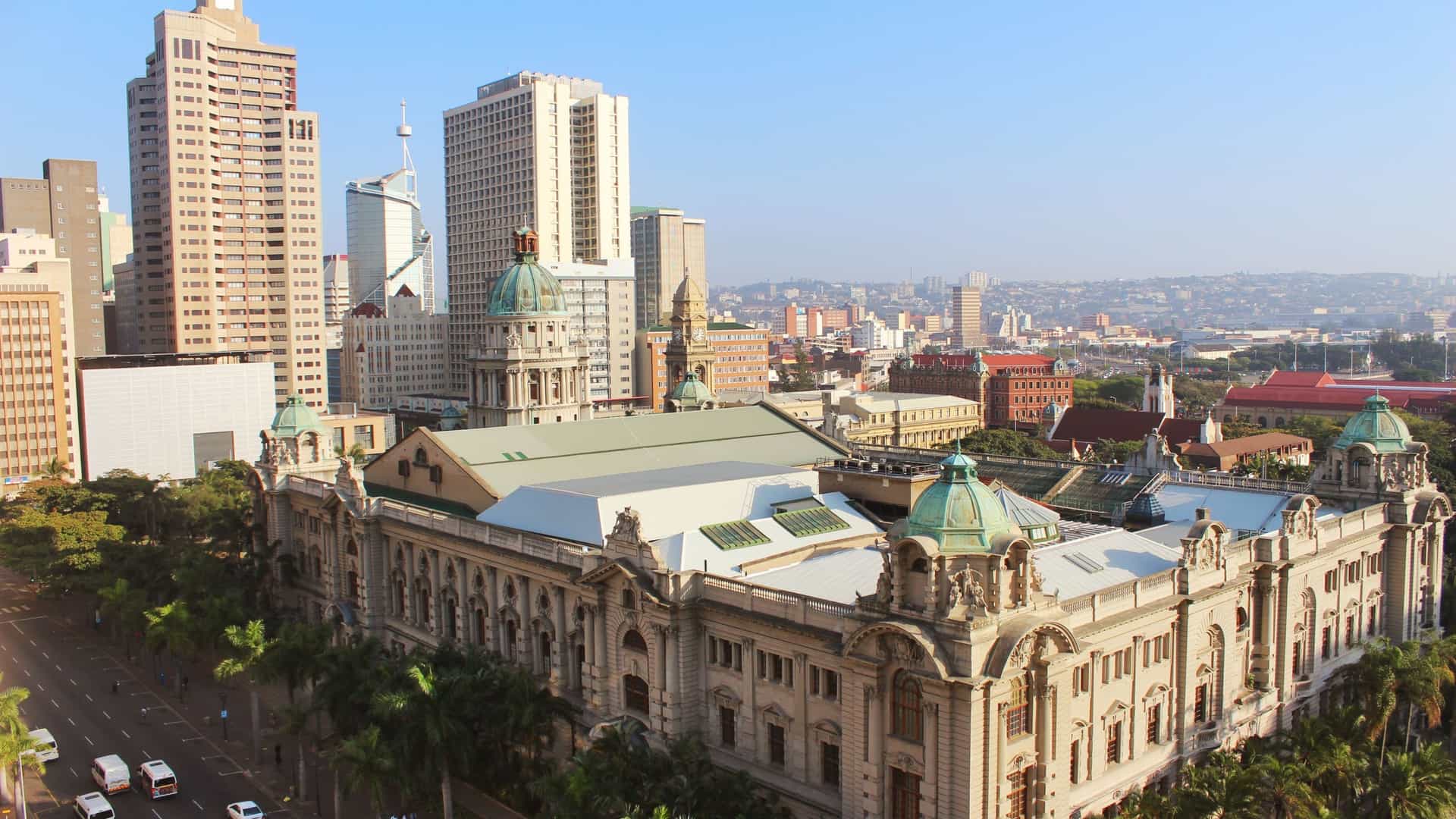 A blend of historical buildings and modern skyscrapers defining the skyline of the Durban city center in South Africa, illustrating the city's architectural evolution.