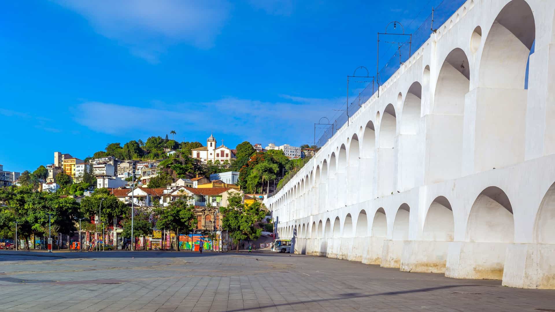 The historic Arcos da Lapa (Lapa Arches) in Rio de Janeiro, Brazil, a monumental two tiered, white stone aqueduct with 42 Roman style arches. The structure, which originally carried water but now serves as a viaduct for the iconic Santa Teresa Tram, spans the lively bohemian Lapa neighborhood.
