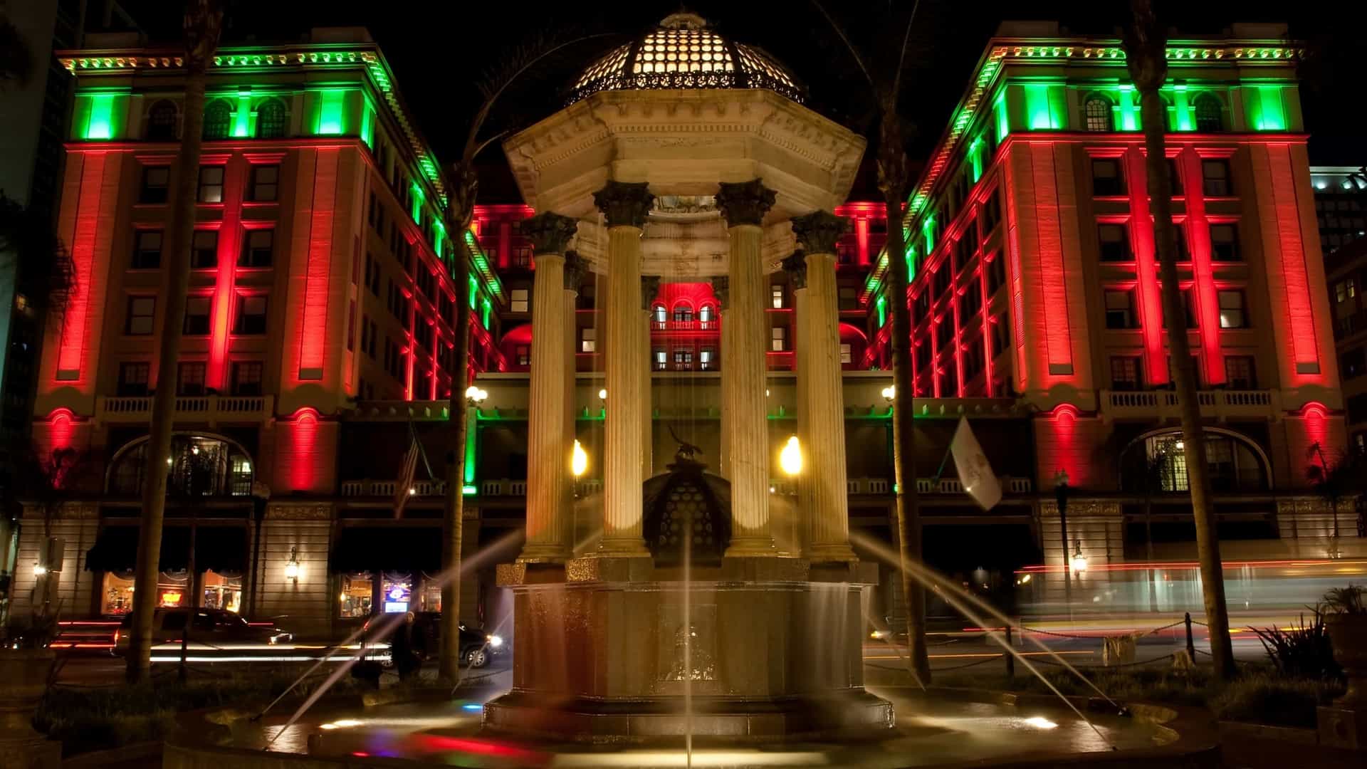 A view of the Gaslamp Quarter, the historic 16.5 block neighborhood in Downtown San Diego, California. The street is lined with preserved Victorian era buildings, which house restaurants and shops, and is illuminated by the area's iconic, ornamental gaslamp streetlights. The image captures the historic character of the district.