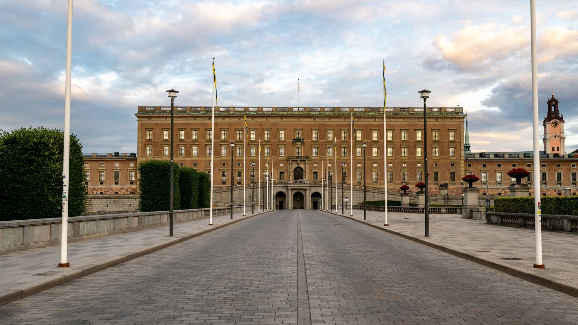 The Royal Palace (Kungliga Slotten) in Stockholm, Sweden, a grand Baroque style stone building that serves as the official residence of the Swedish monarch. The image likely shows one of the palace's facades, characterized by a stately, symmetrical design with numerous windows.