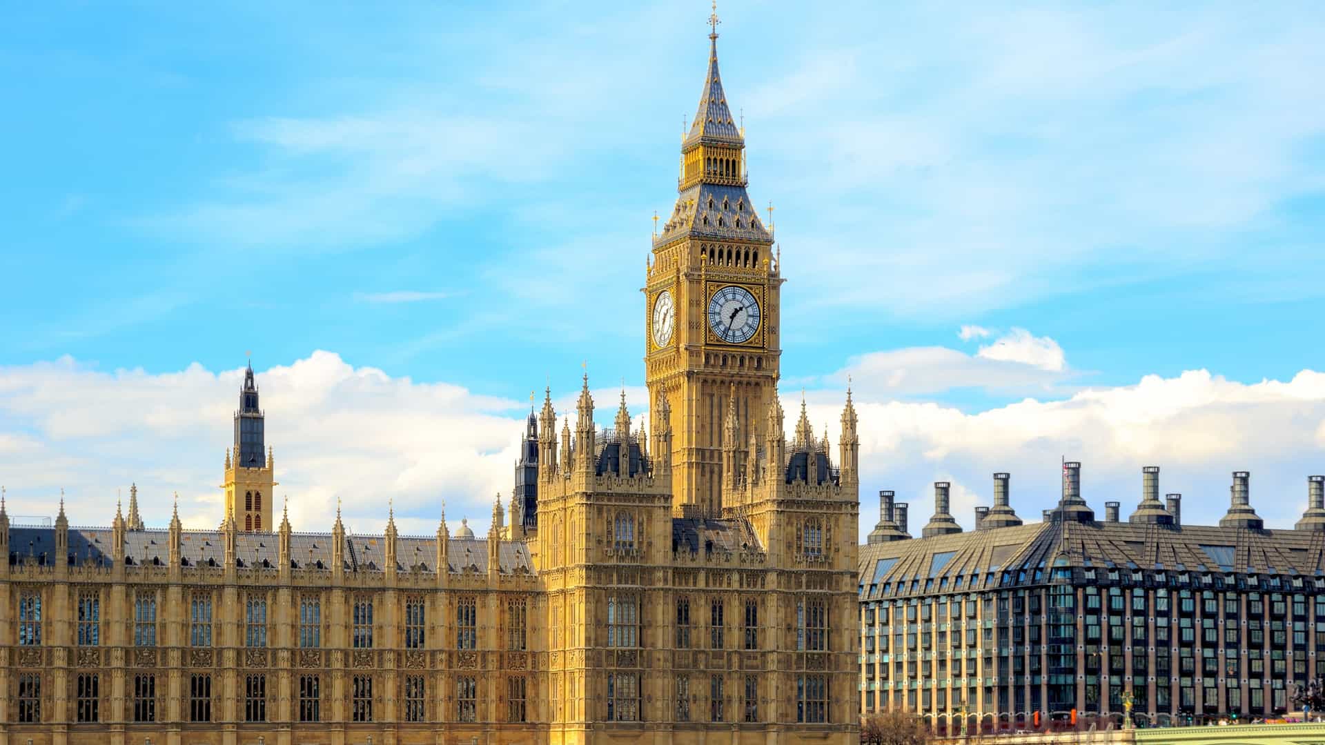 The Gothic Revival architecture of the Houses of Parliament (Palace of Westminster) in London, UK, with the iconic clock tower, the Elizabeth Tower (commonly known as Big Ben), standing tall against the sky. The scene captures the famous British landmark.
