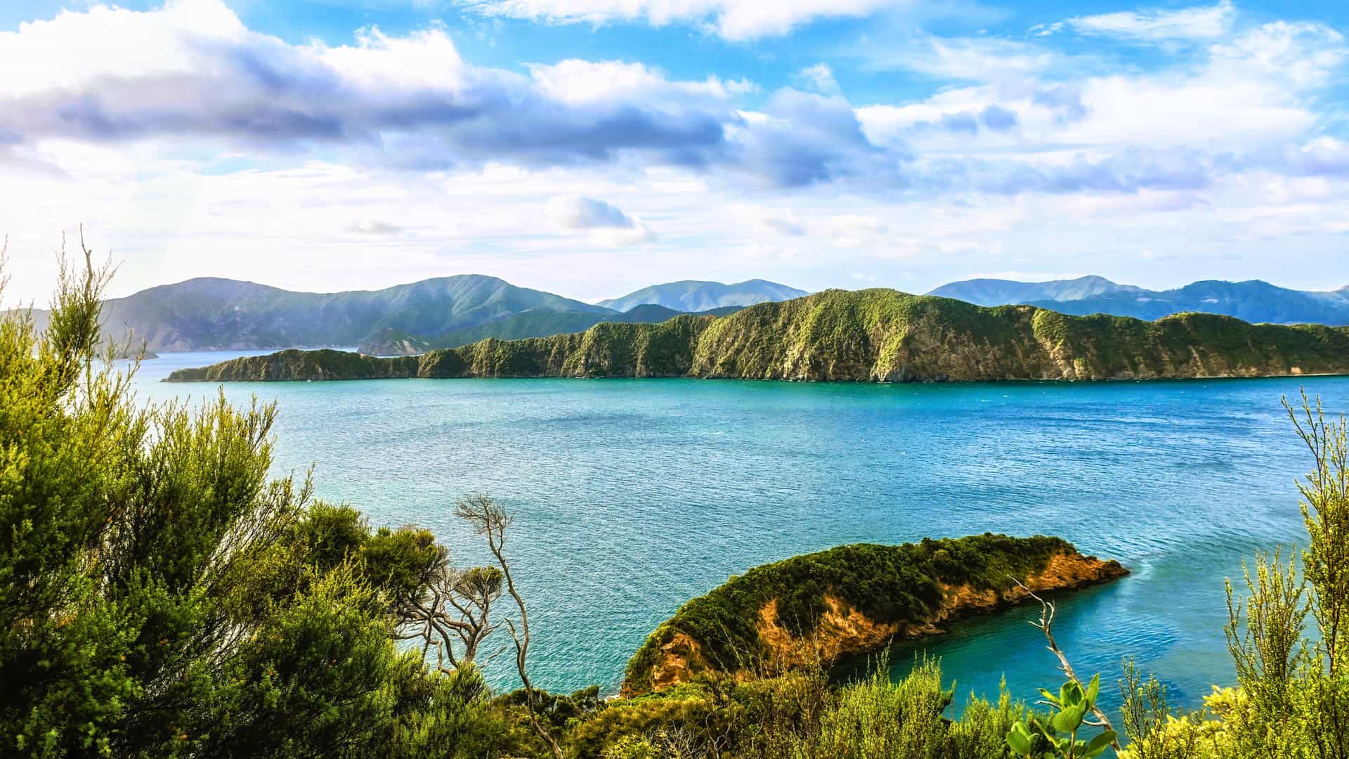 Explora journey scenic view of lush green islands, blue waters, and mountains during a transpacific crossing.