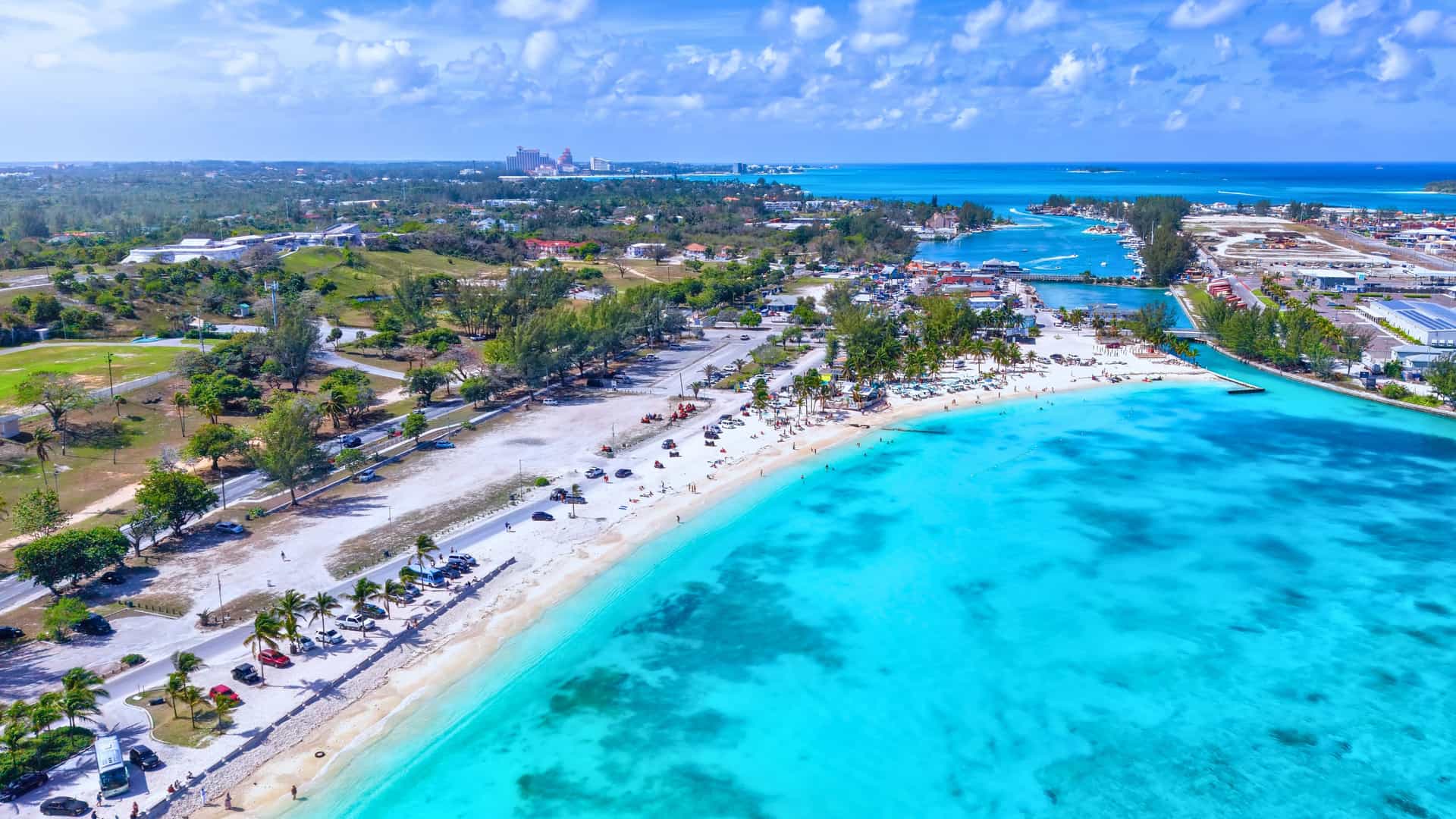 Explora journey aerial view of a vibrant tropical beach with white sand and turquoise water in the Western Caribbean.