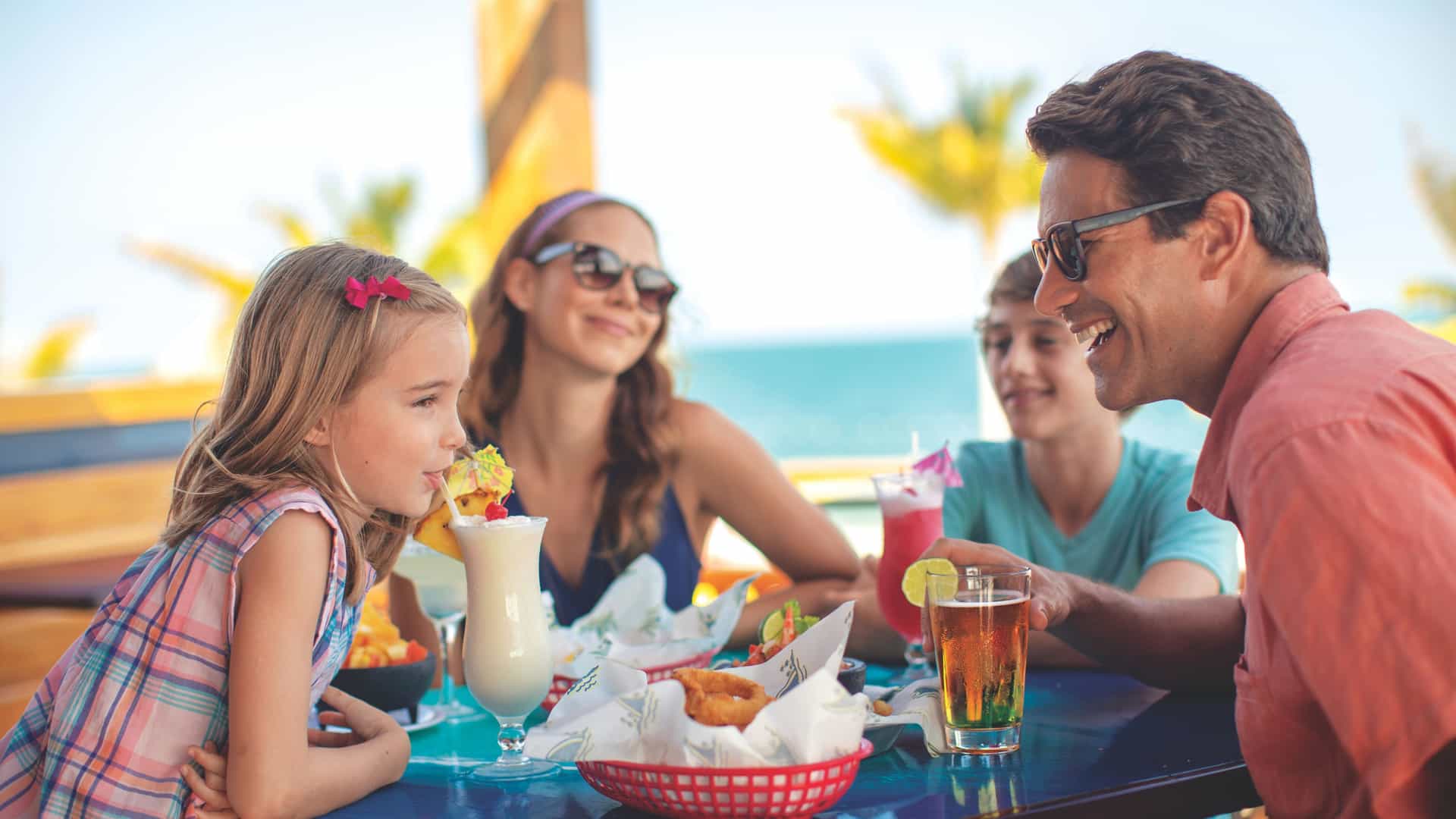 Family dining together at Landshark at Norwegian's Harvest Caye.