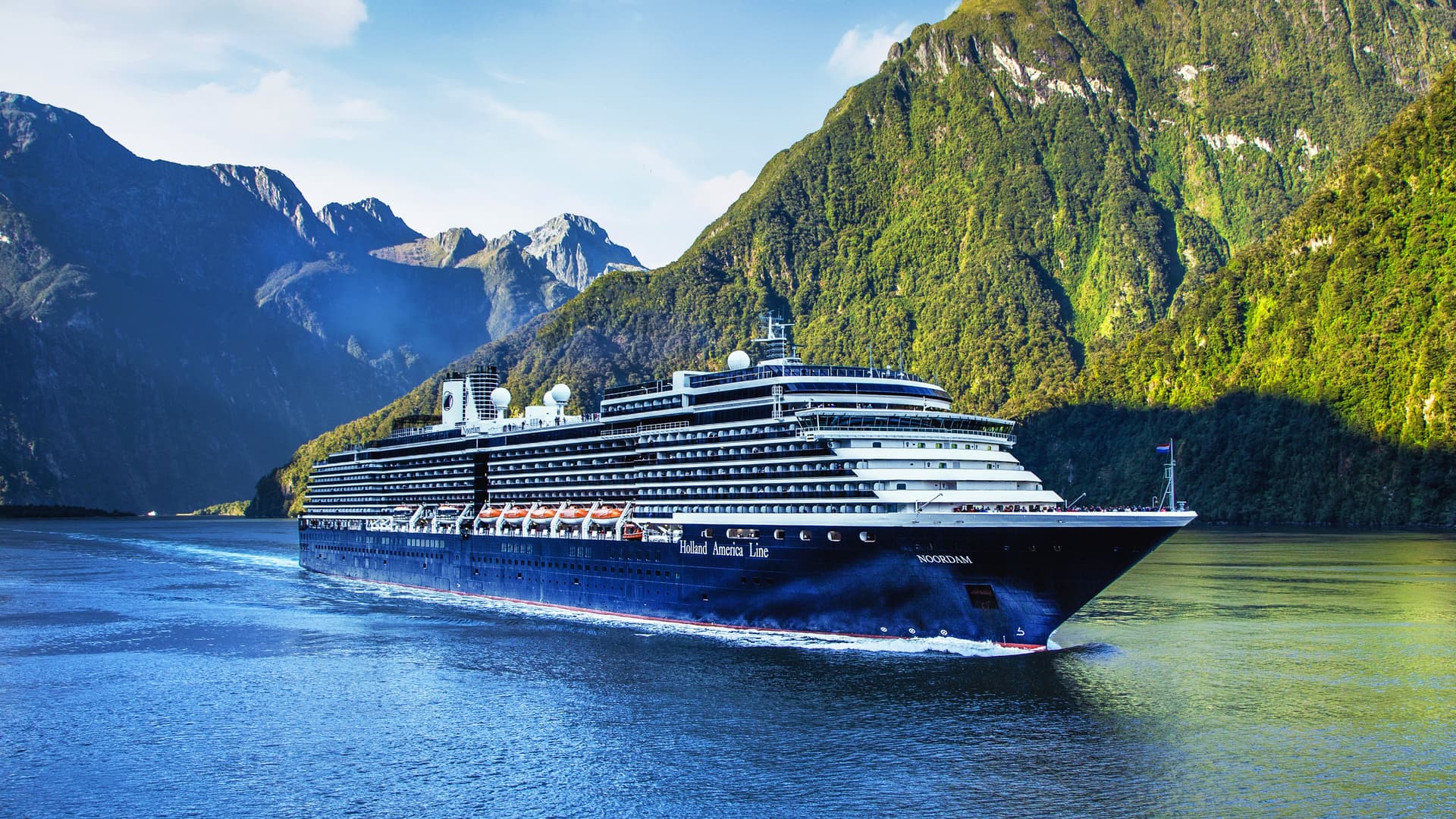 Holland America's Noordam sailing in a fjord.