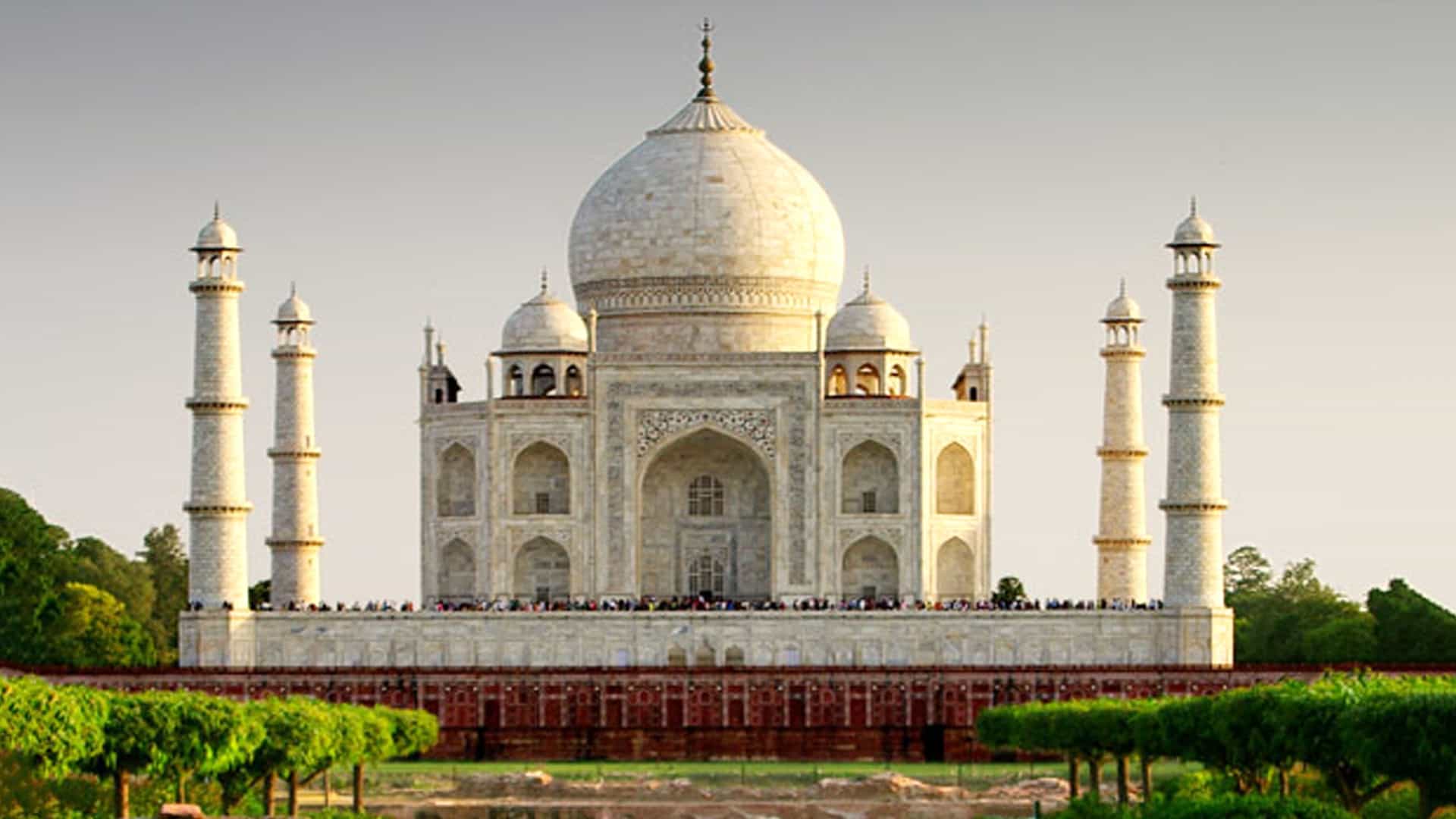 The Taj Mahal is a stunning white building with multiple towers and intricate designs.