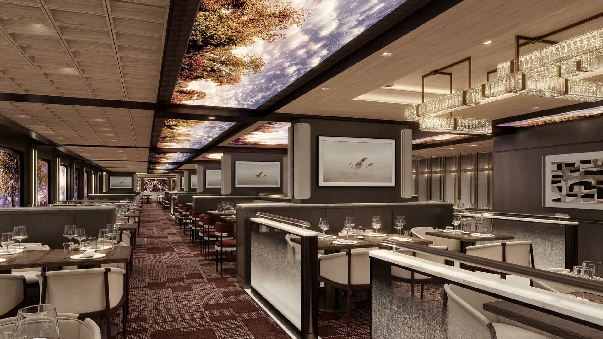 An upscale cruise ship restaurant interior features glowing ceiling panels depicting a scenic sky, modern chandeliers, and neatly arranged dining tables with white chairs.