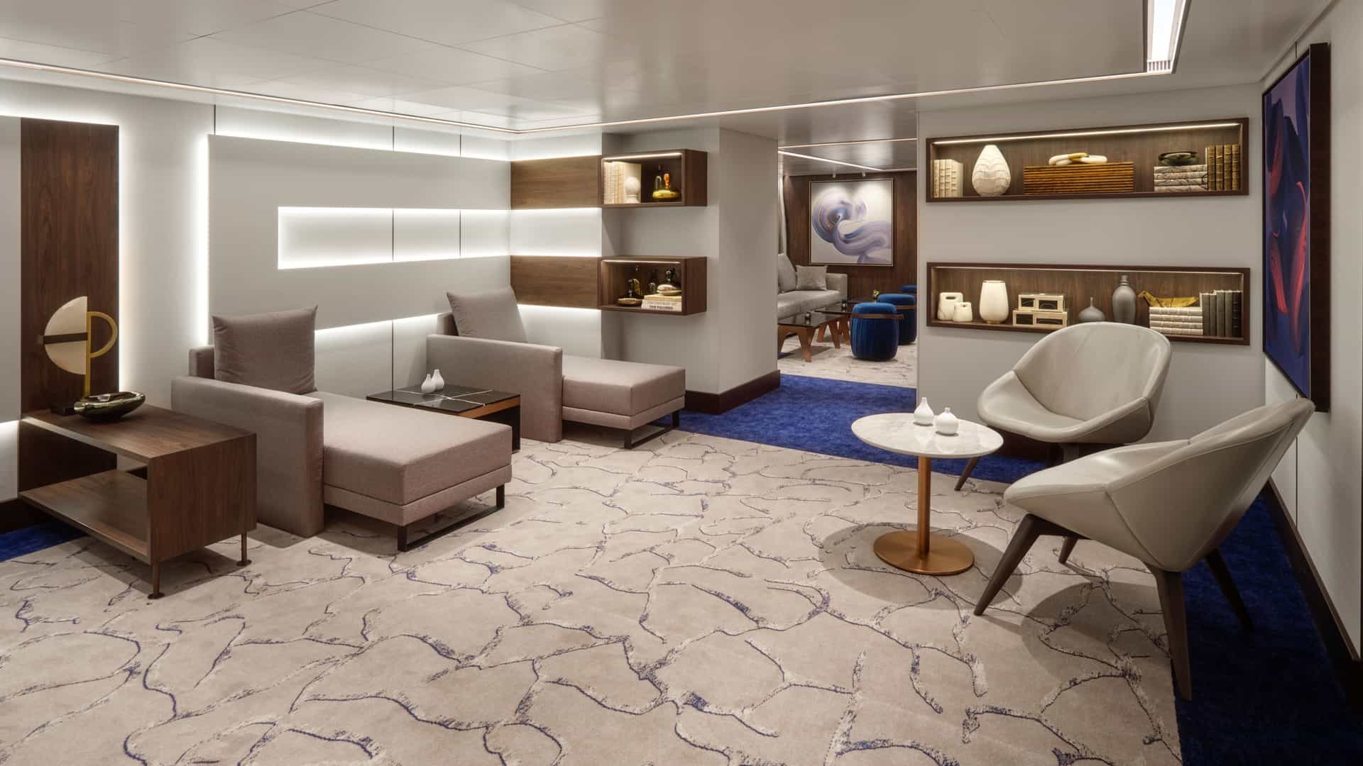 Studio Lounge on Norwegian Prima with chaise lounges, leather armchairs, a round table and built-in shelving.